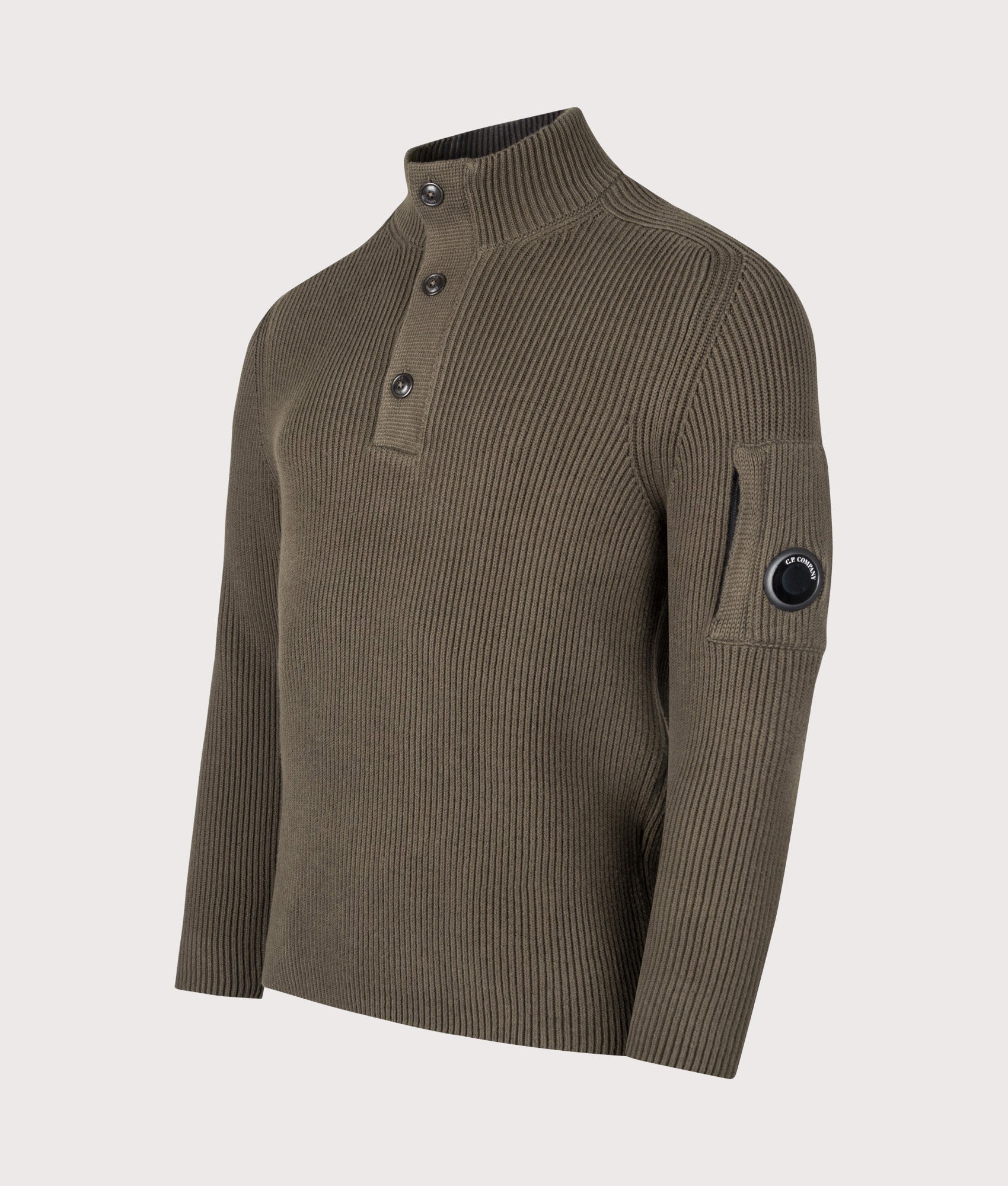 C.P. Company Full Rib Cotton Half Button Lens Jumper in Ivy Green at EQVVS Menswear. Angled front shot.