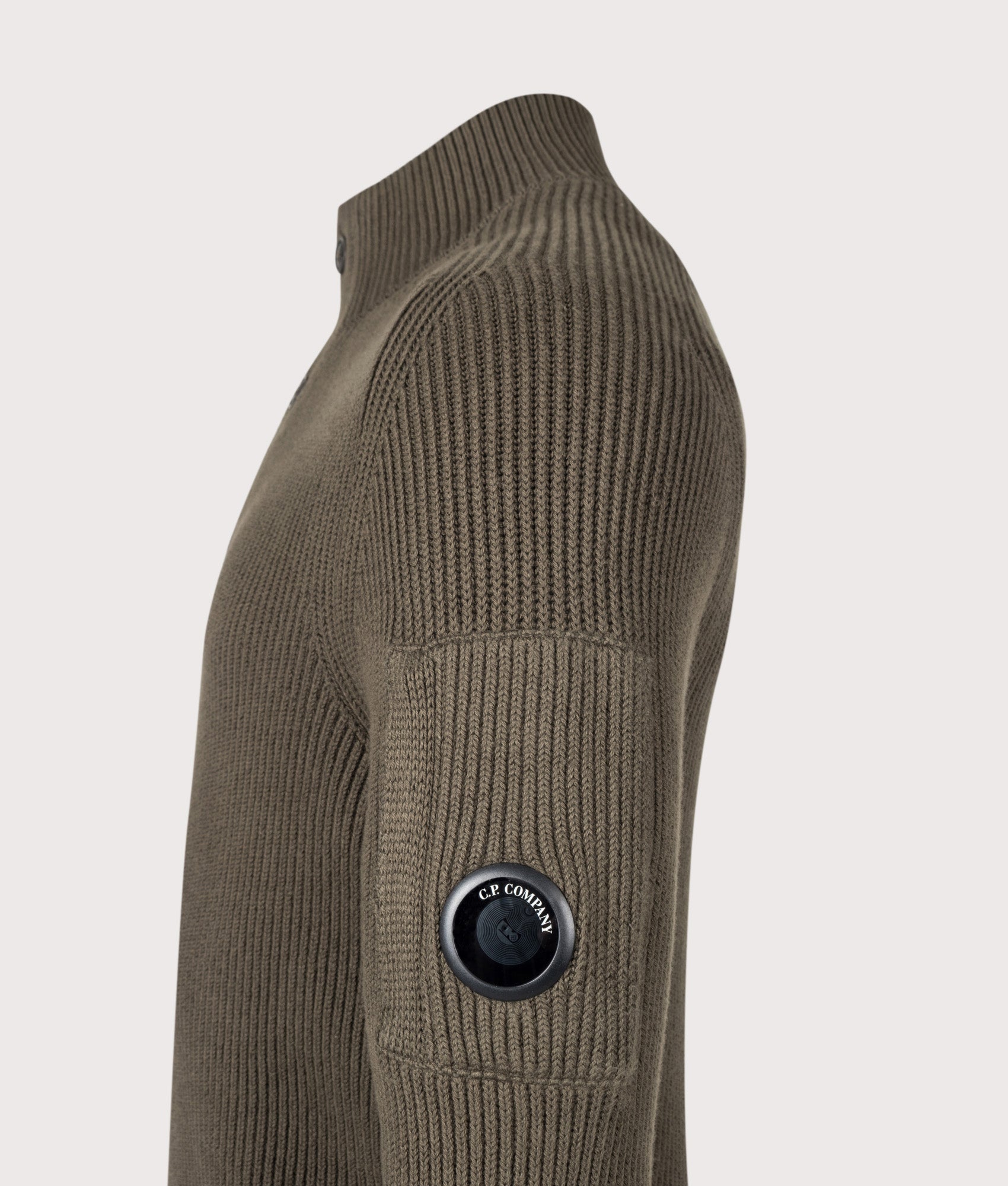 C.P. Company Full Rib Cotton Half Button Lens Jumper in Ivy Green at EQVVS Menswear. Detail shot.
