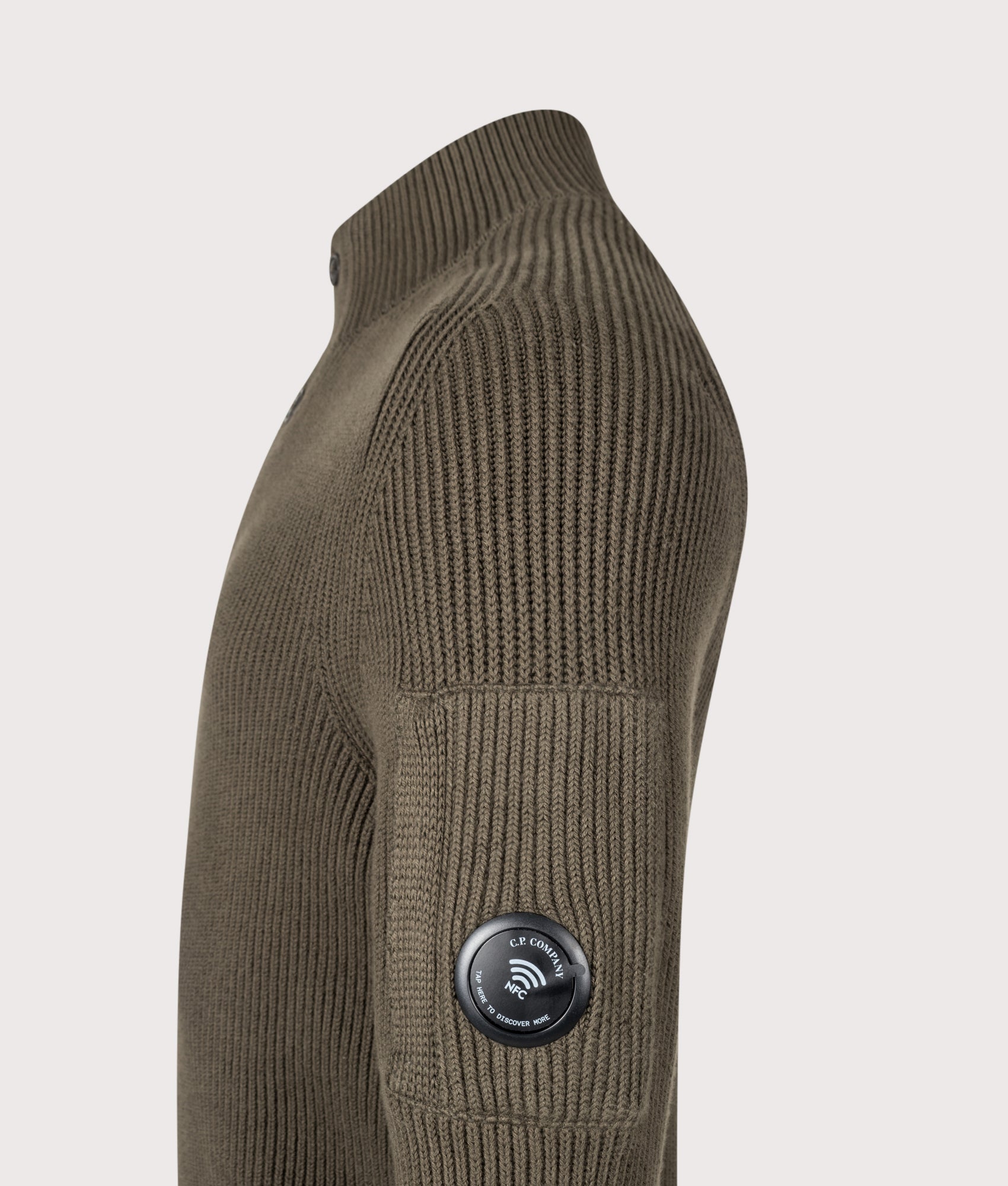 C.P. Company Full Rib Cotton Half Button Lens Jumper in Ivy Green at EQVVS Menswear. NFC Detail shot.