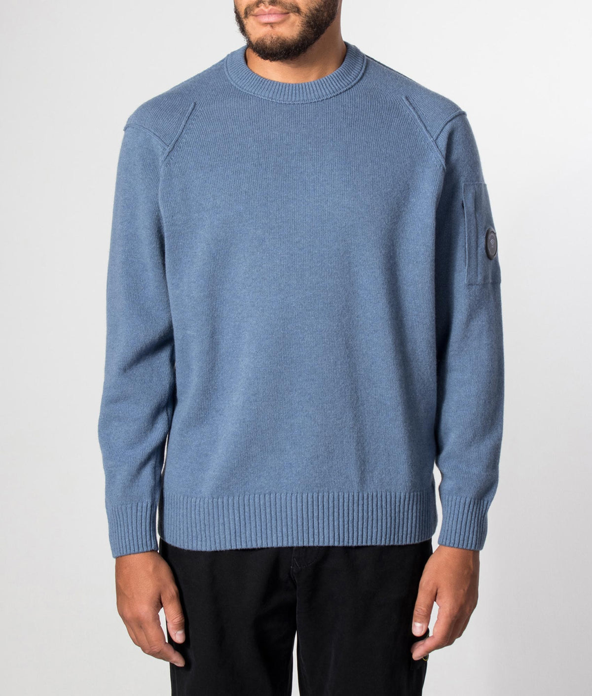 C.P. Company Lambswool GRS Crewneck Lens Jumper in Orion Blue at EQVVS Menswear. Model front shot.