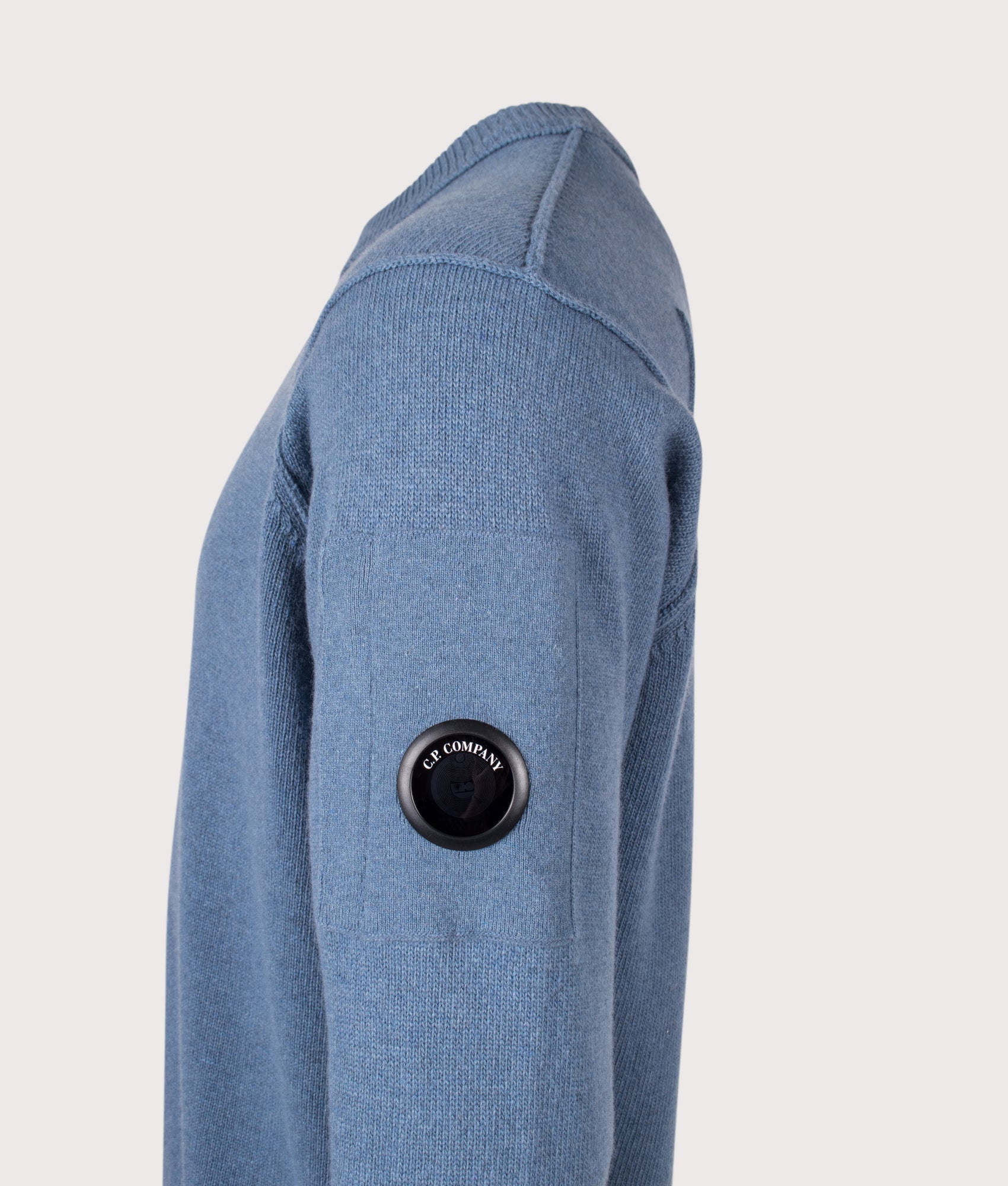 C.P. Company Lambswool GRS Crewneck Lens Jumper in Orion Blue at EQVVS Menswear. Detail shot.