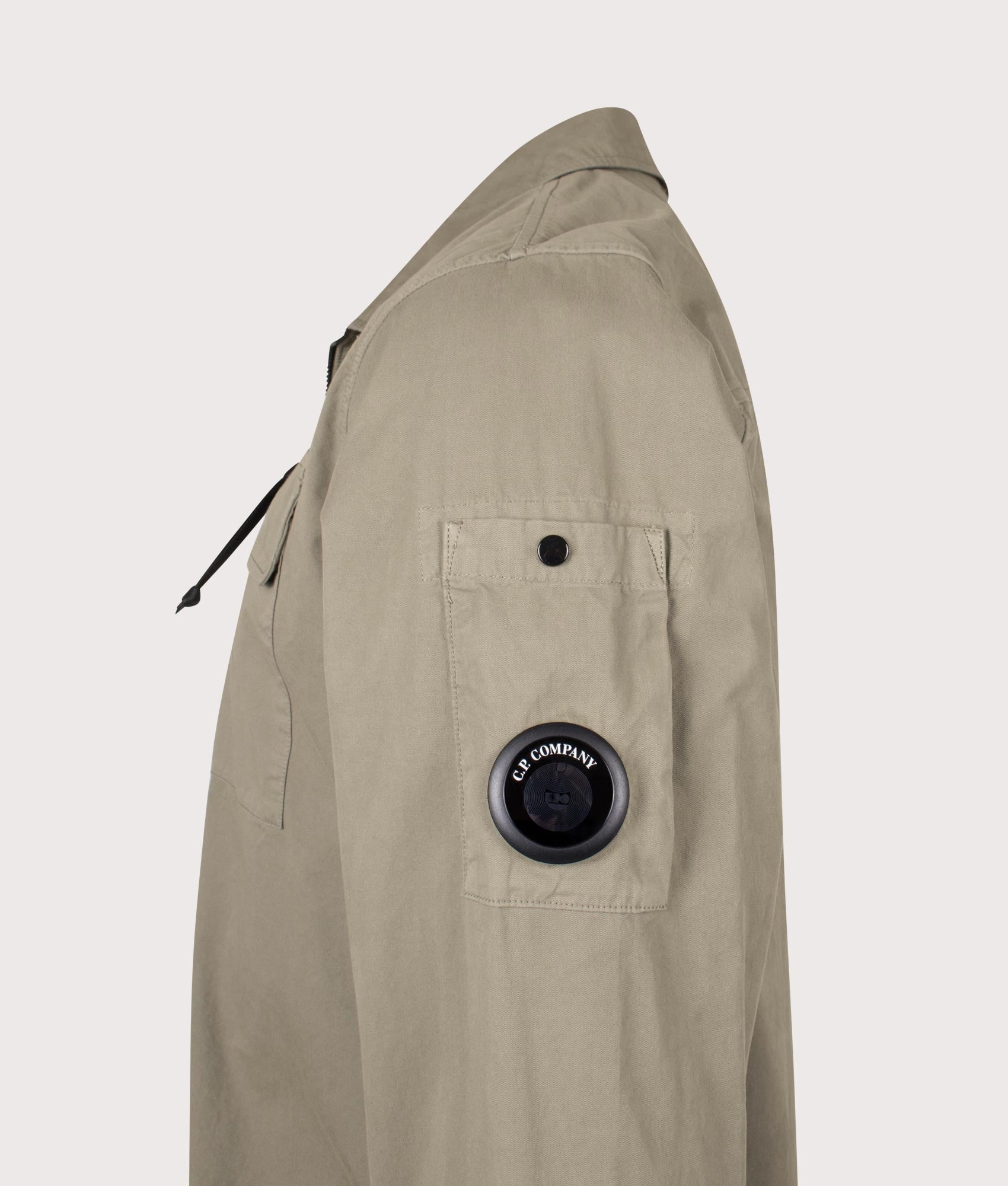 C.P. Company Organic Gabardine Zipped Lens Overshirt in Fallen Rock at EQVVS Menswear. Detail shot.