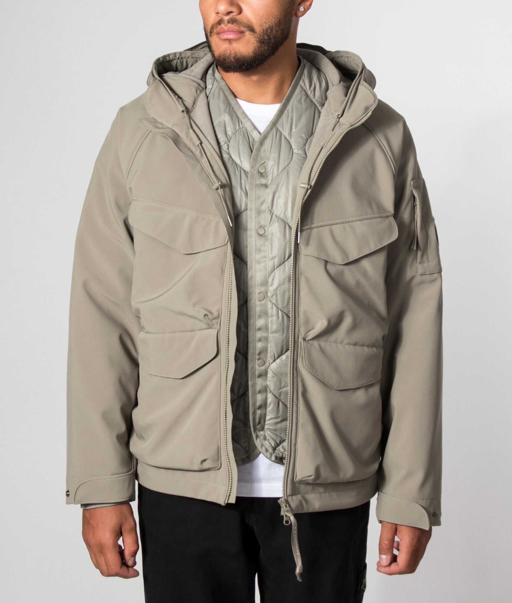 C.P. Company C.P. Shell-R Padded Hooded Lens Jacket in Fallen Rock at EQVVS Menswear. Model front shot.