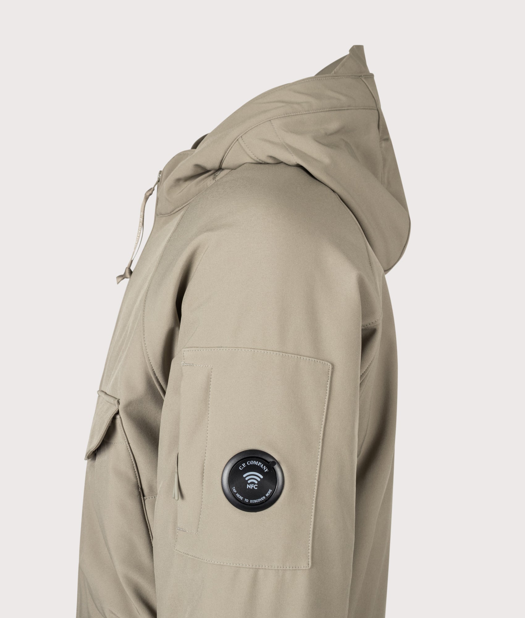 C.P. Company C.P. Shell-R Padded Hooded Lens Jacket in Fallen Rock at EQVVS Menswear. NFC Detail shot.