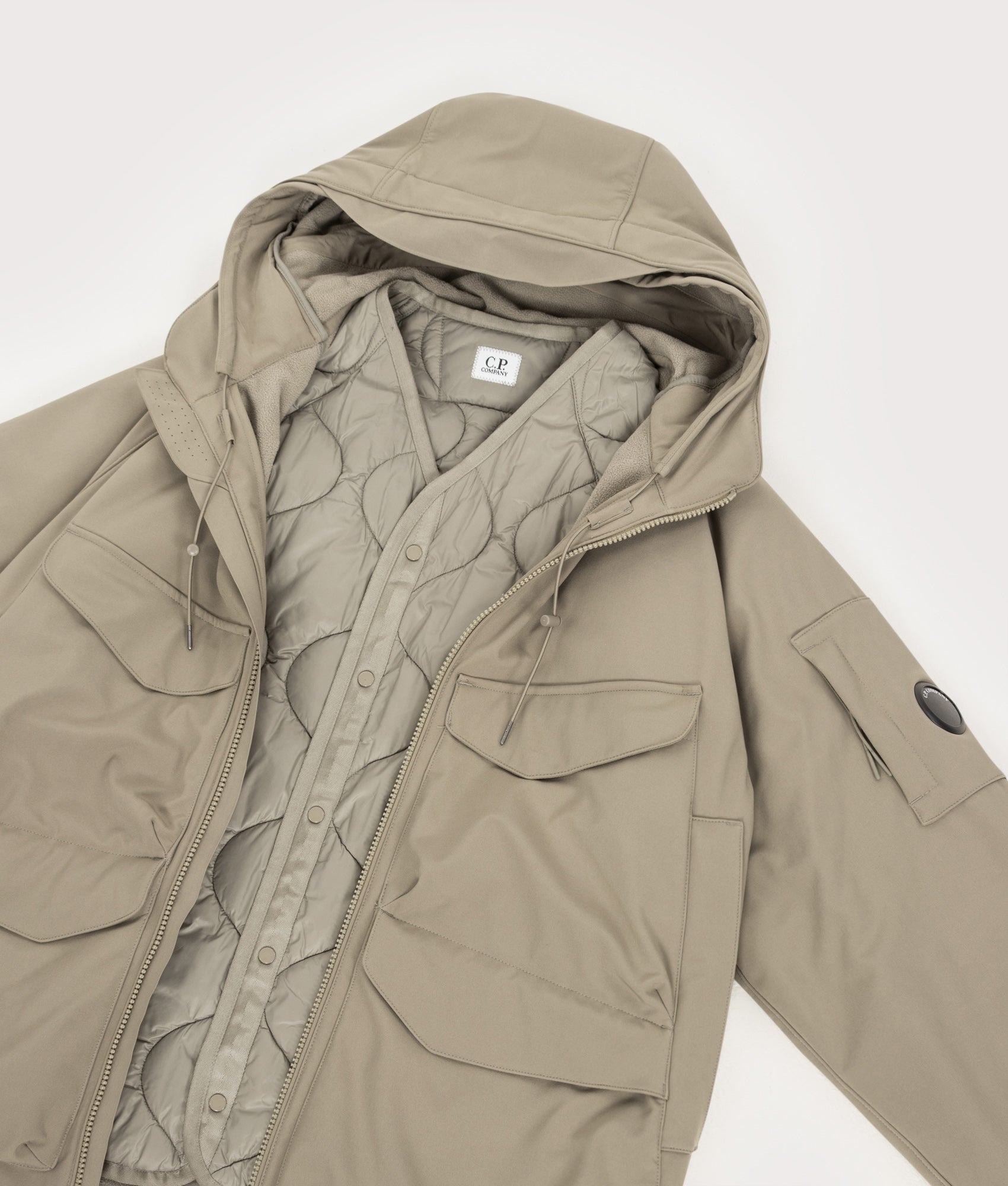 C.P. Company C.P. Shell-R Padded Hooded Lens Jacket in Fallen Rock at EQVVS Menswear. Flat liner shot