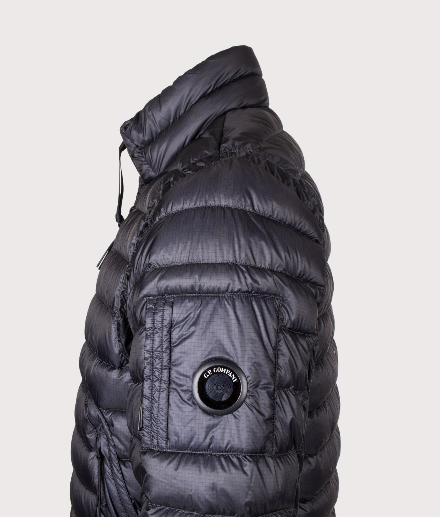 C.P. Company D.D. Shell Lens Down Jacket in Black at EQVVS Menswear. Detail shot.