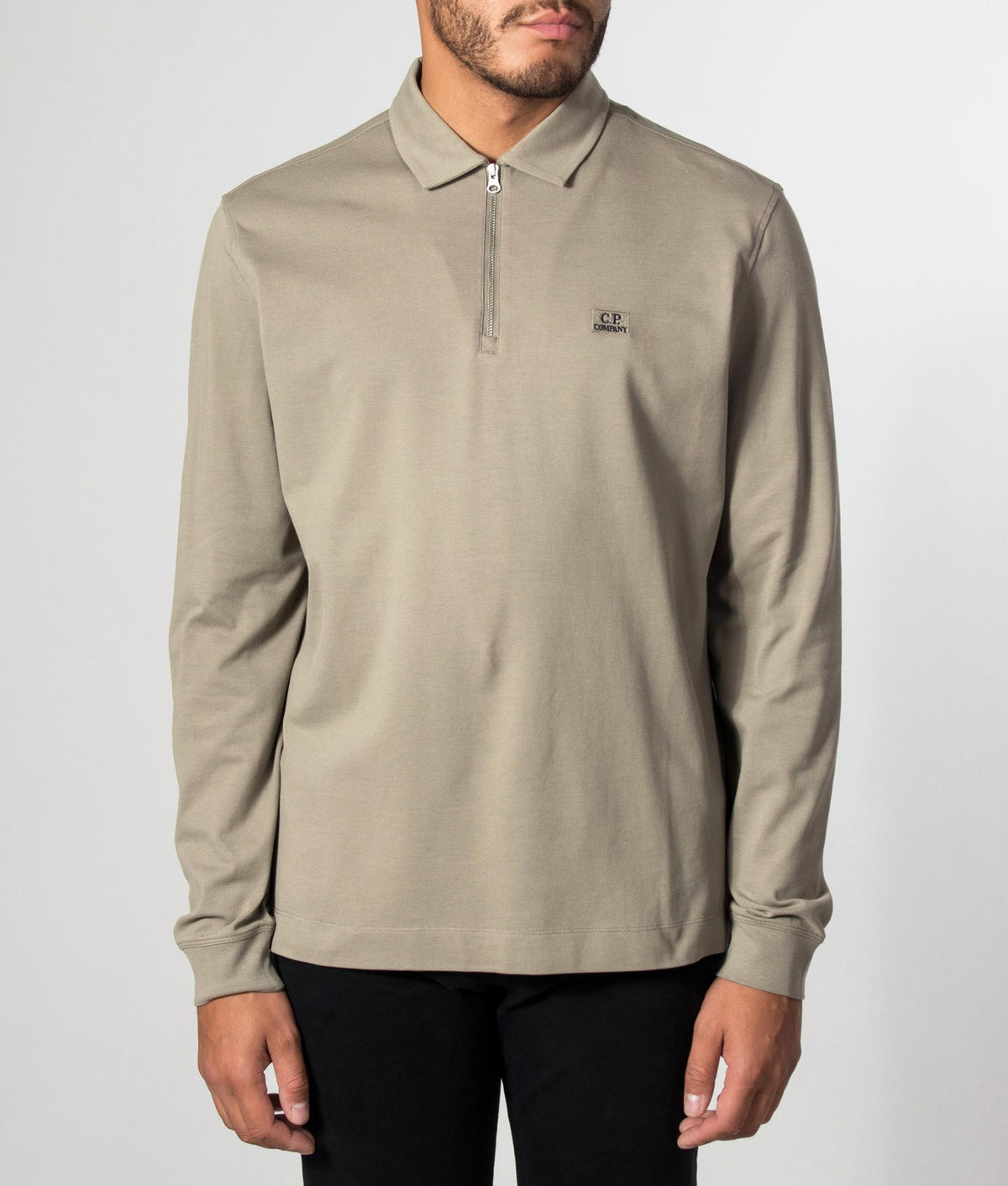 C.P. Company Long Sleeve Stretch Piquet Zip Polo Shirt in Fallen Rock at EQVVS Menswear. Model front shot.