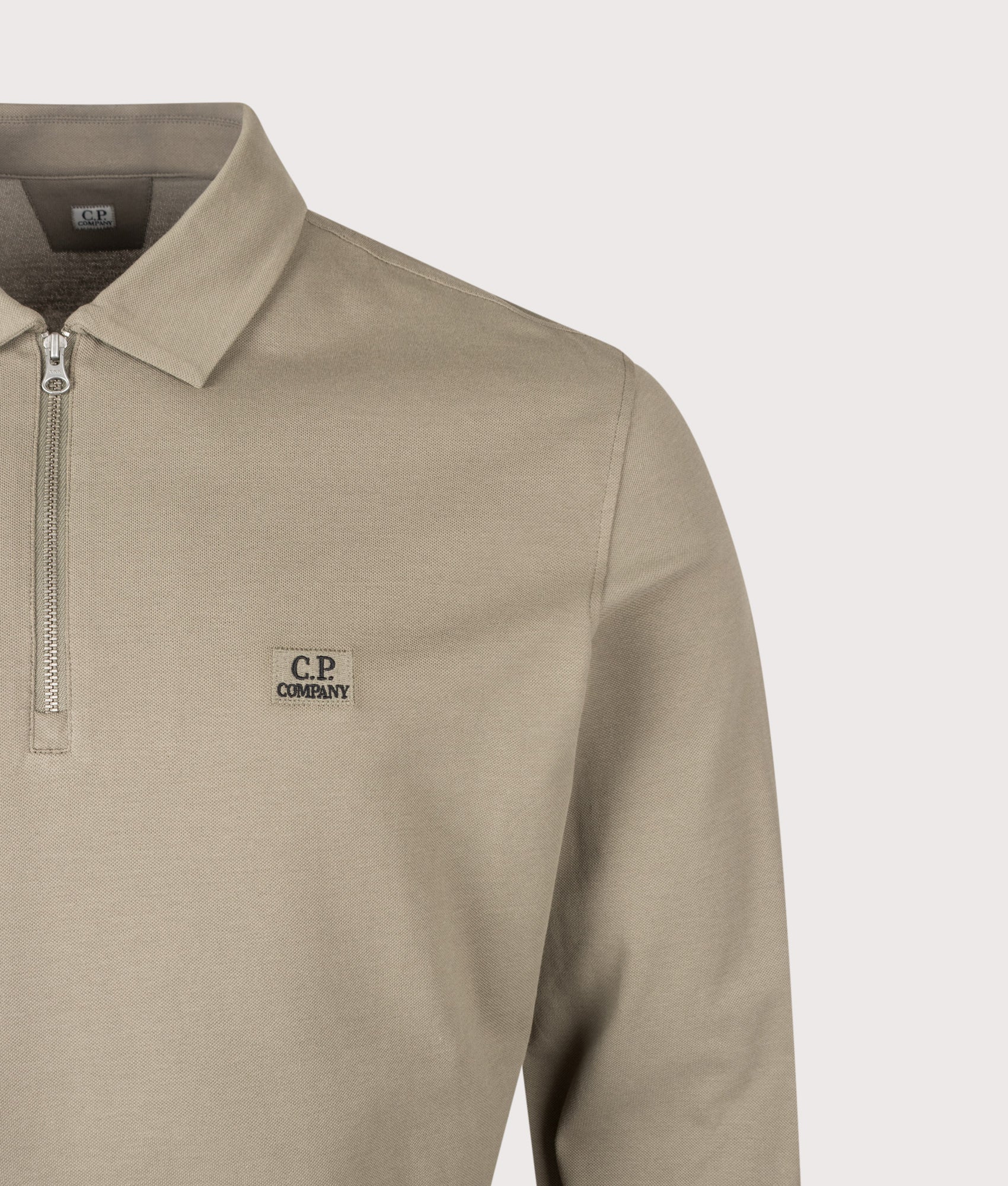 C.P. Company Long Sleeve Stretch Piquet Zip Polo Shirt in Fallen Rock at EQVVS Menswear. Detail shot.