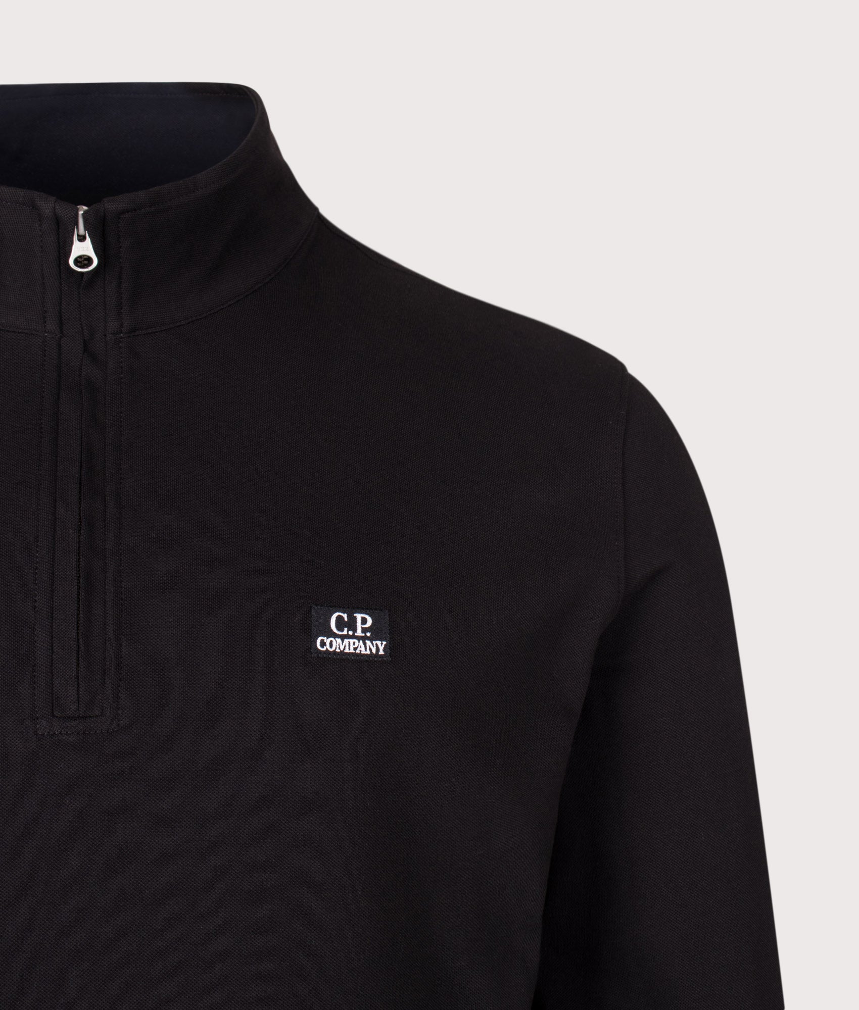 C.P. Company Stretch Piquet Quarter Zip Sweatshirt in Black at EQVVS Menswear. Detail shot.