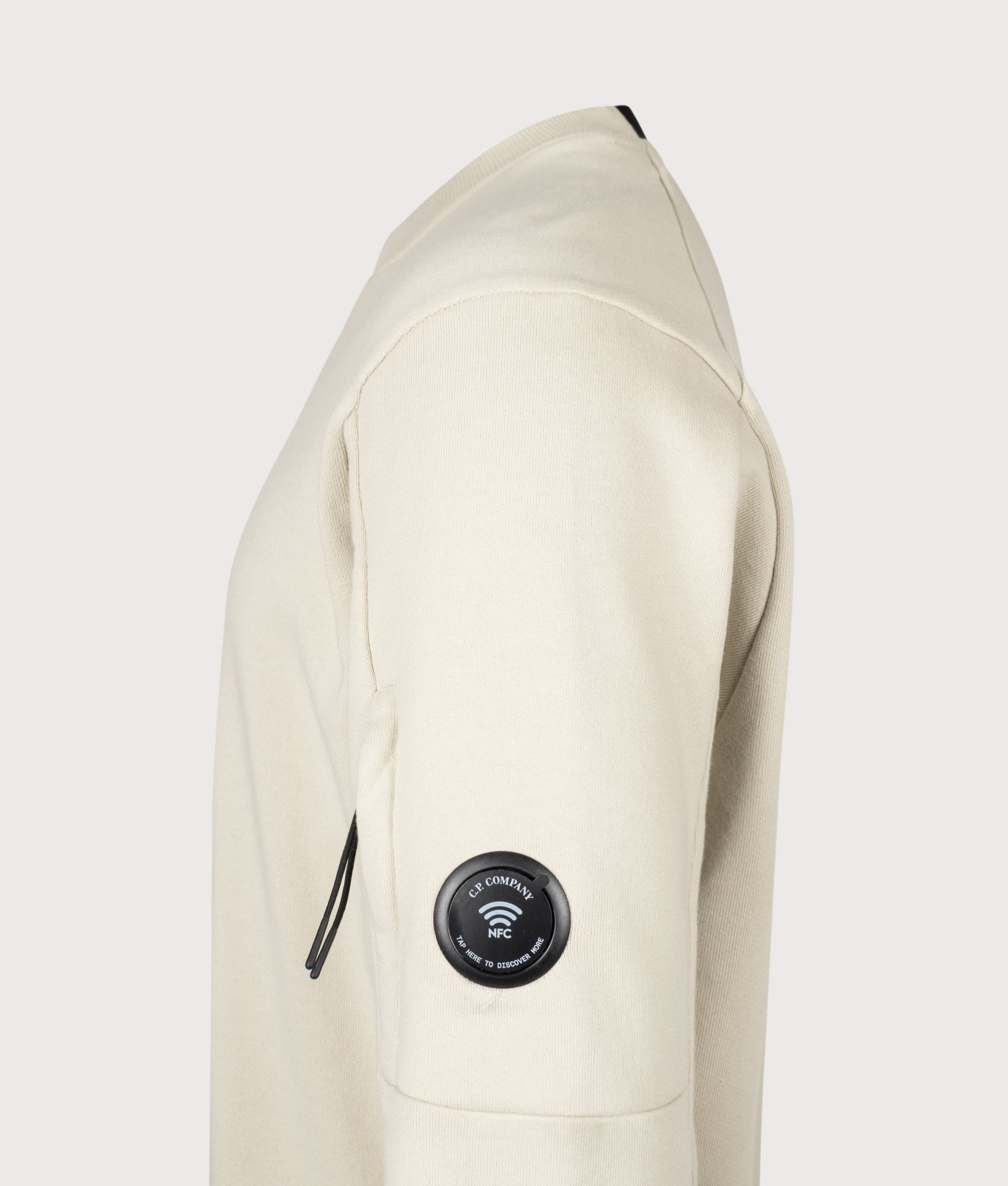 C.P. Company Diagonal Raised Fleece Crewneck Lens Sweatshirt in Silver Birch at EQVVS Menswear. NFC Detail shot.