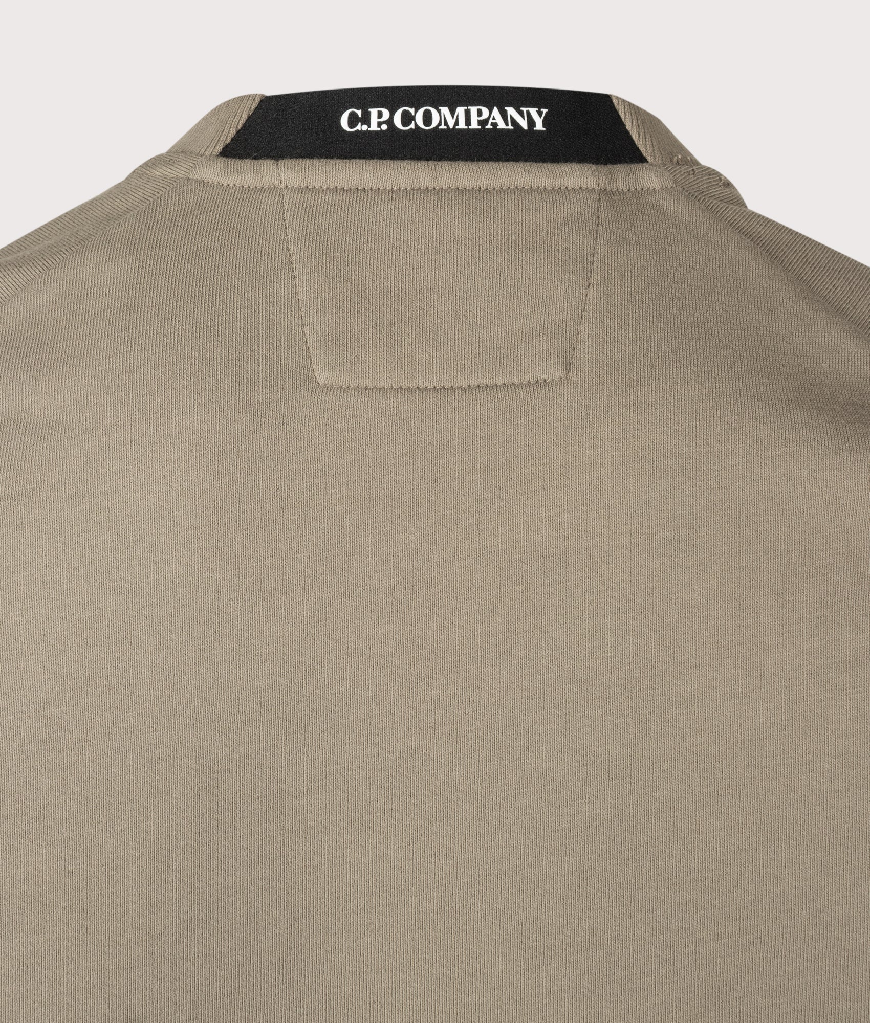 C.P. Company Diagonal Raised Fleece Crewneck Lens Sweatshirt in Fallen Rock at EQVVS Menswear. Neck detail shot.