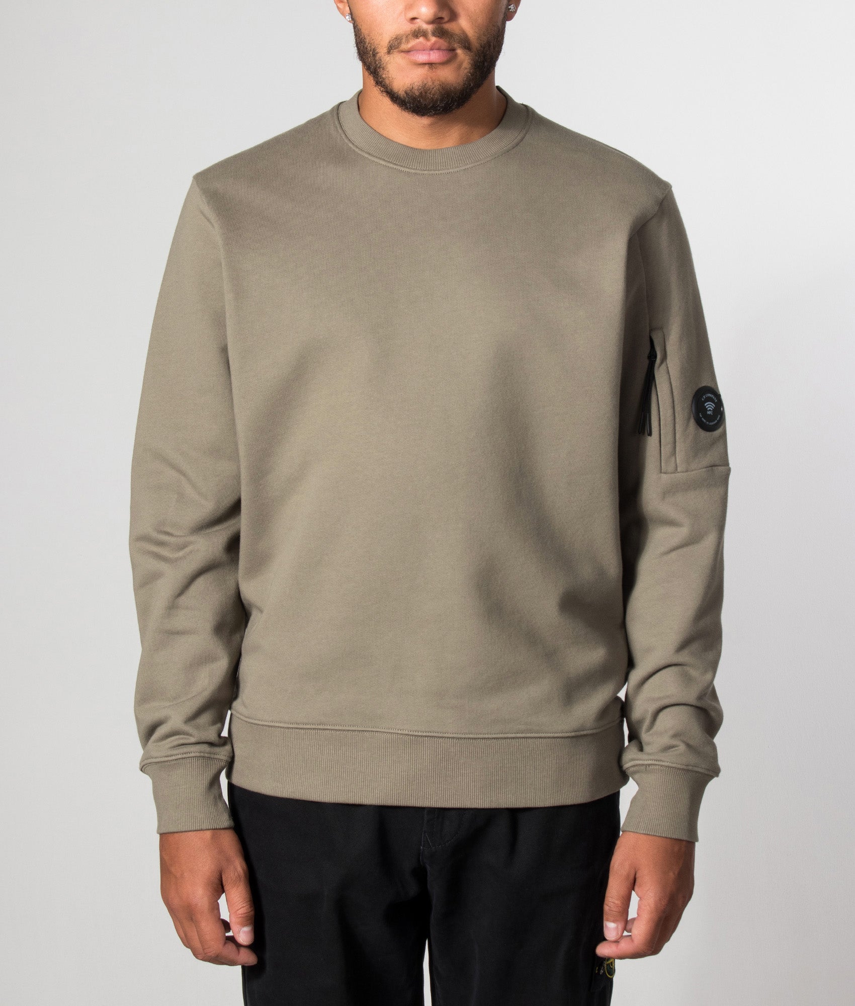 C.P. Company Diagonal Raised Fleece Crewneck Lens Sweatshirt in Fallen Rock at EQVVS Menswear. Model front shot.