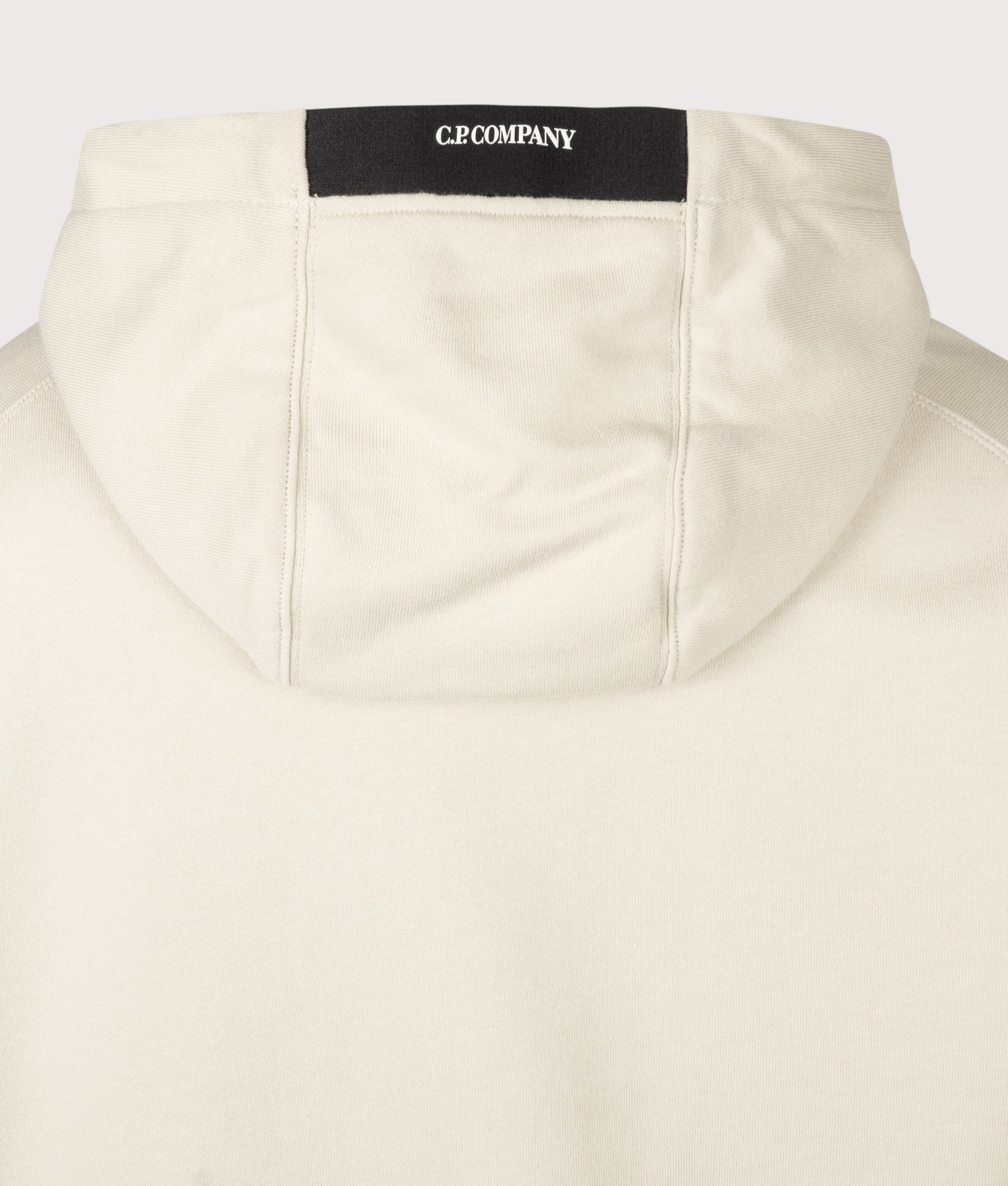 C.P. Company Diagonal Raised Fleece Lens Hoodie in Silver Birch at EQVVS Menswear. Hood detail shot.