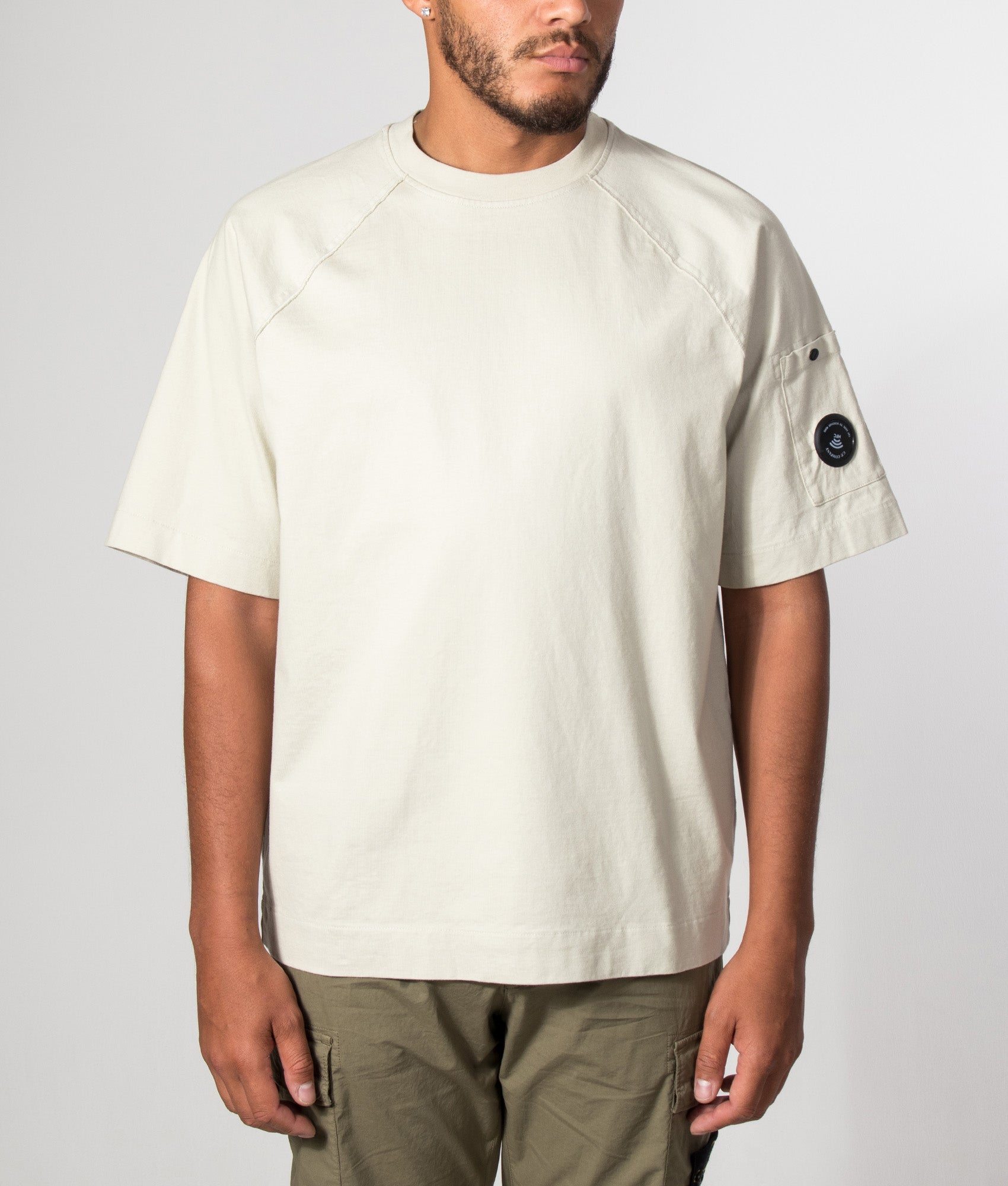 C.P. Company 30/2 Mercerized Jersey Twisted Lens T-Shirt in Silver Birch at EQVVS Menswear. Model front shot.