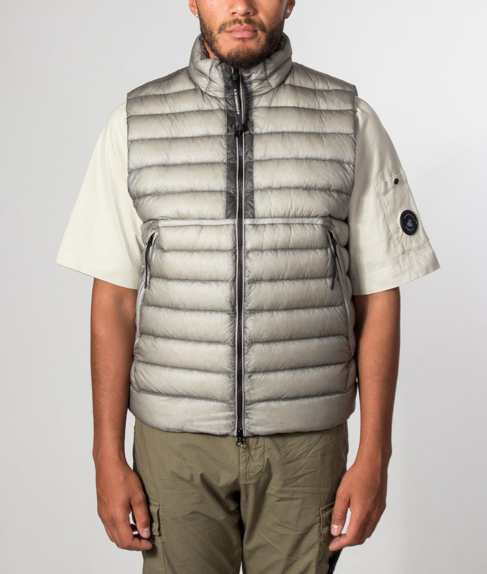 C.P. Company D.D. Shell Down Gilet in Flint Grey at EQVVS Menswear. Model front shot.