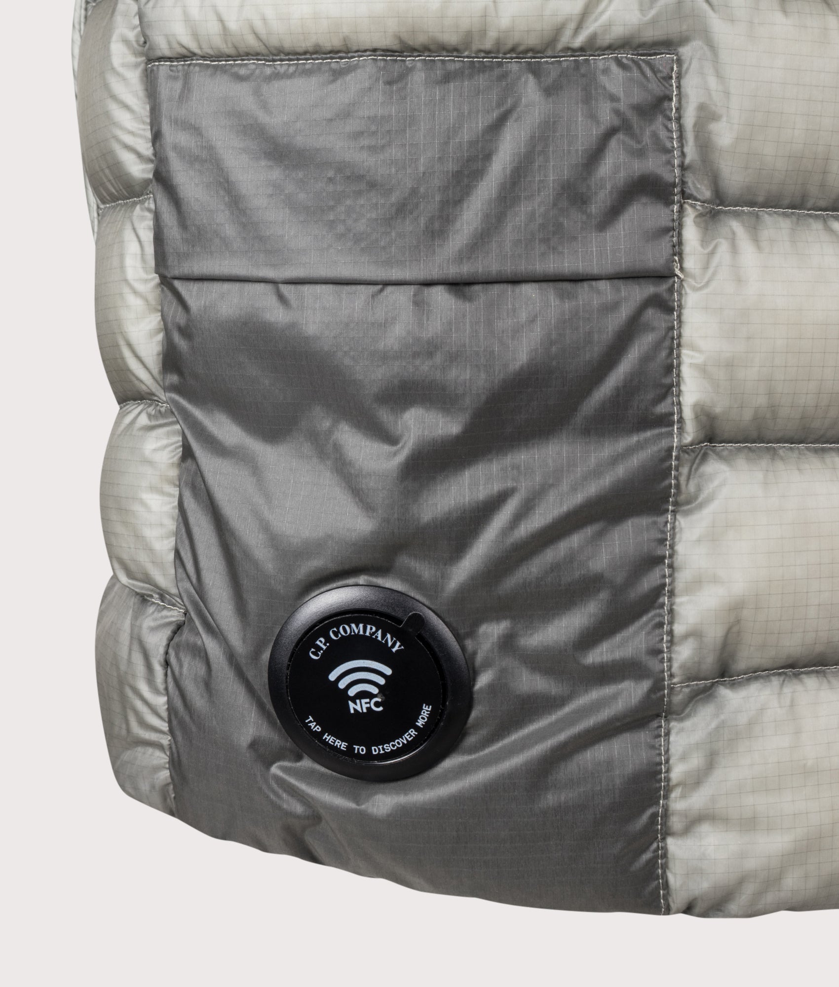 C.P. Company D.D. Shell Down Gilet in Flint Grey at EQVVS Menswear. NFC Detail shot.
