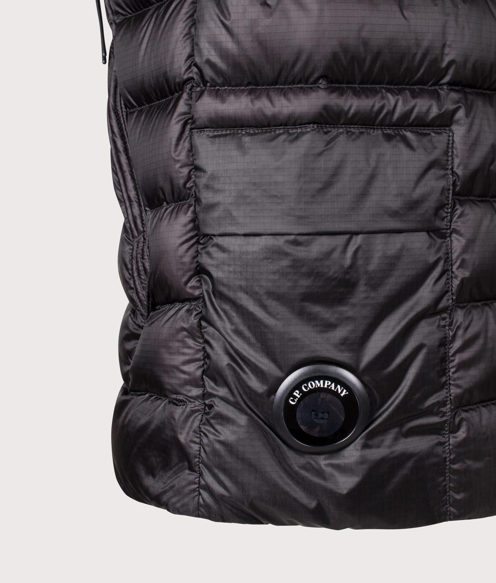 C.P. Company Dd-Shell Down Lens Gilet in Black at EQVVS Menswear. Detail shot.