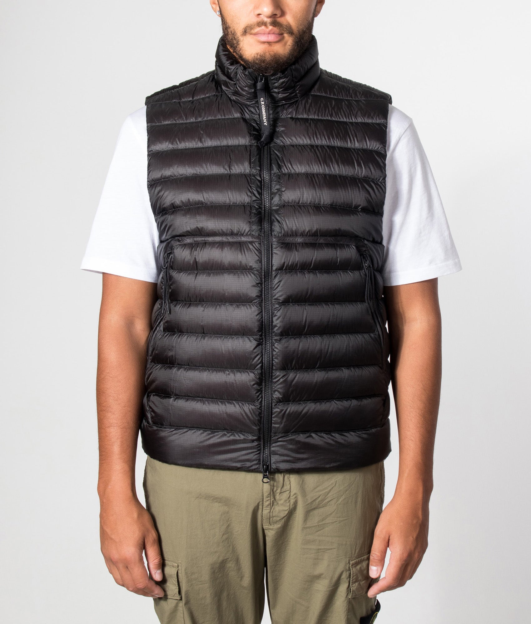 C.P. Company Dd-Shell Down Lens Gilet in Black at EQVVS Menswear. Model front shot.