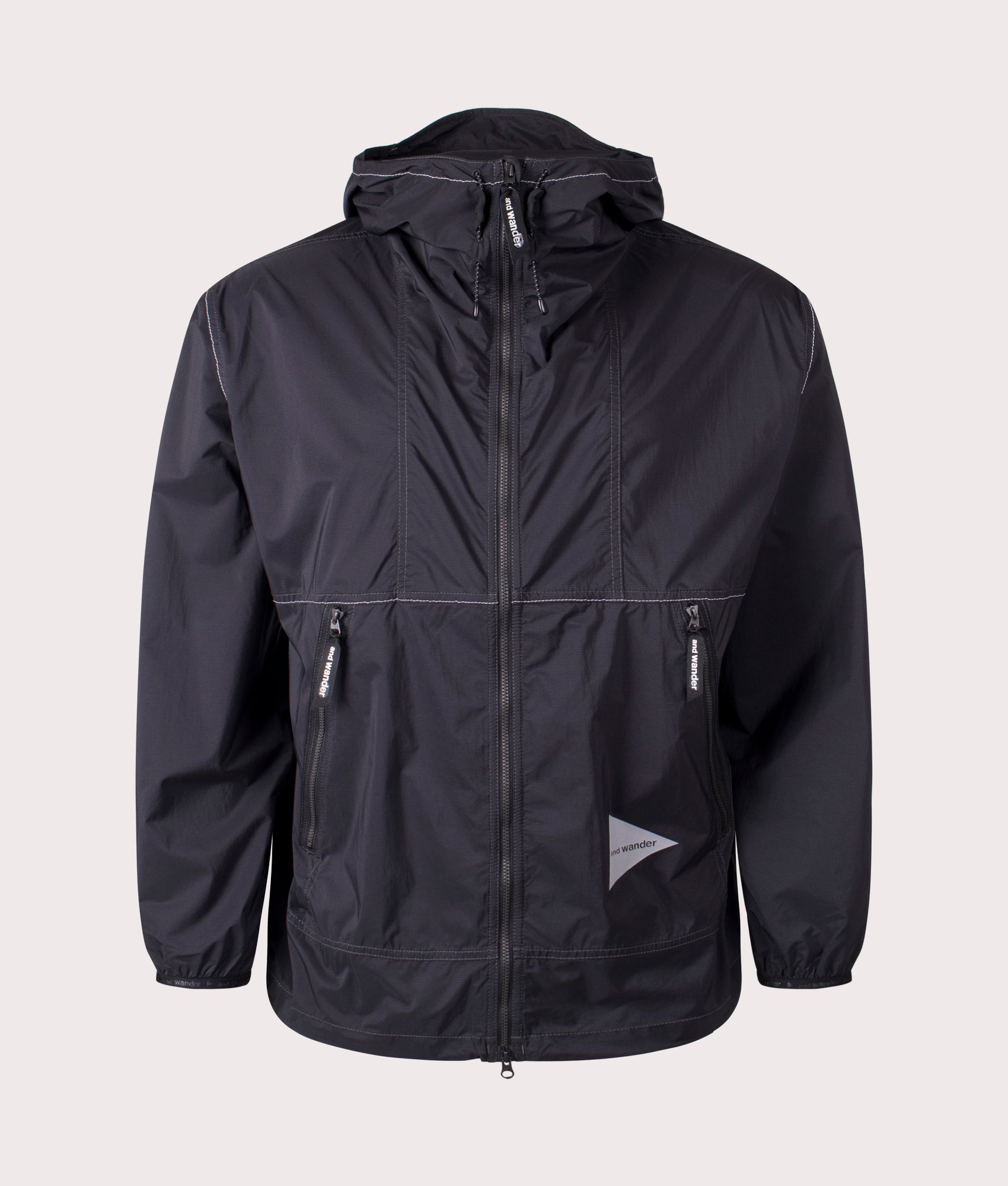 and wander Pertex Wind Jacket in Black at EQVVS. Front Shot.