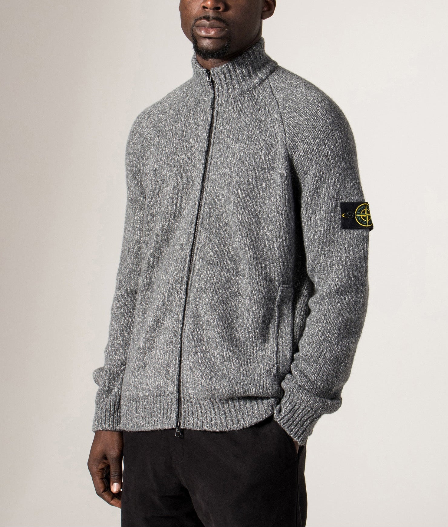 Zip Through Cardigan in Cement Melange. Wool blend | Stone Island | Shot at EQVVS | Side model shot 