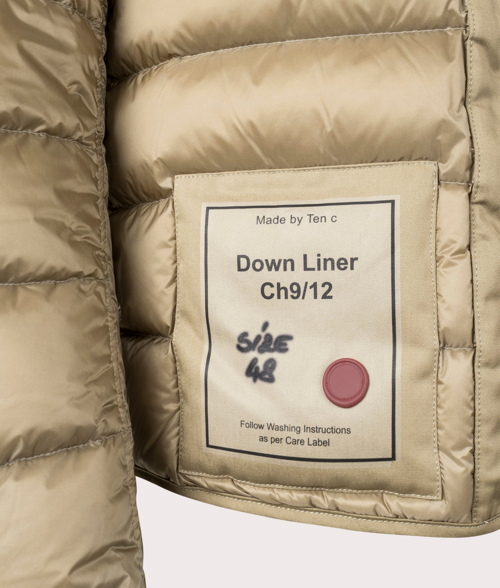 Down Liner Puffer Jacket by Ten c in Light Khaki. Shot by EQVVS. Detail shot.