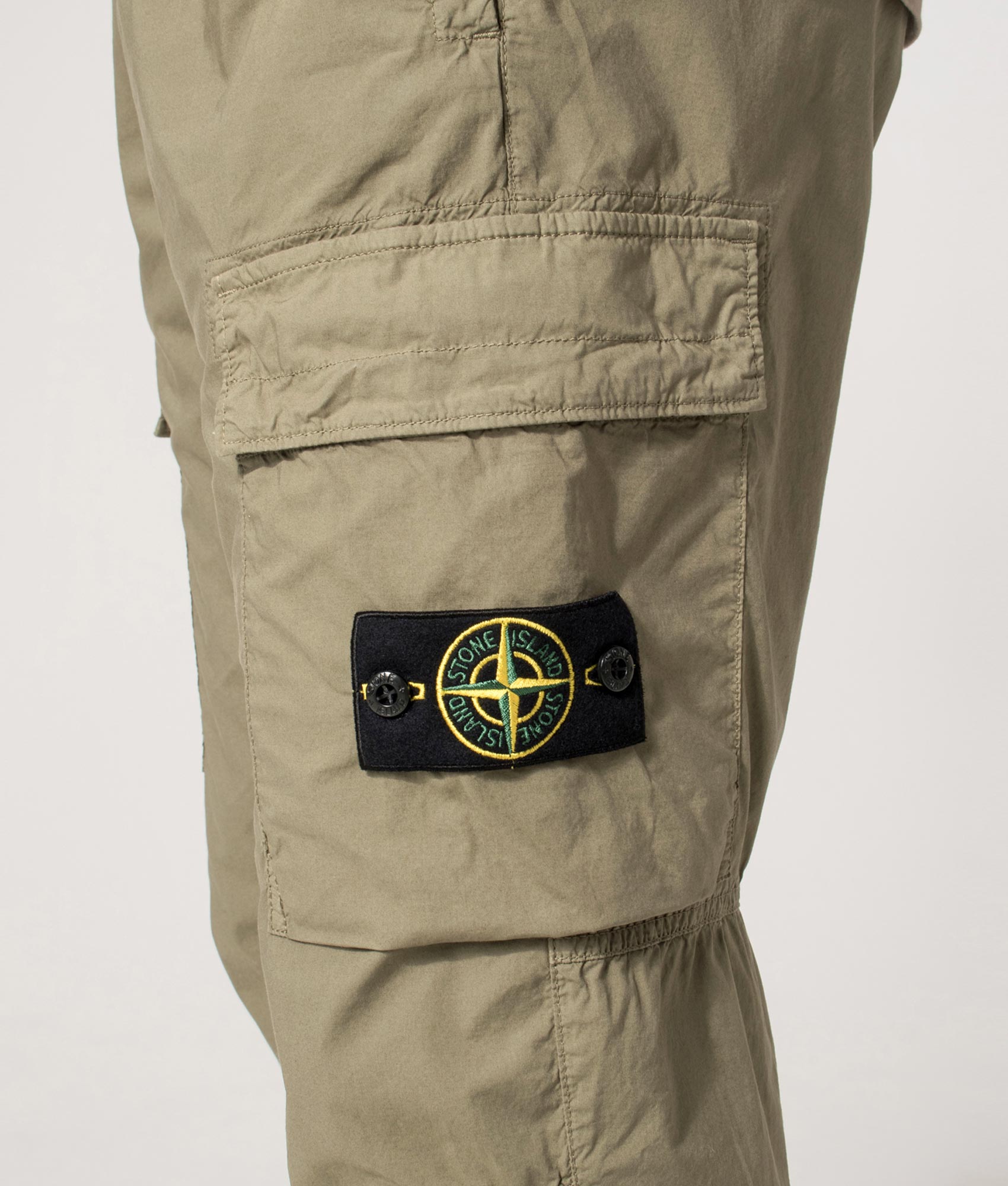 Regular Fit Tapered Cargo Pants in Military Green | Stone Island | EQVVS | Side detail shot 