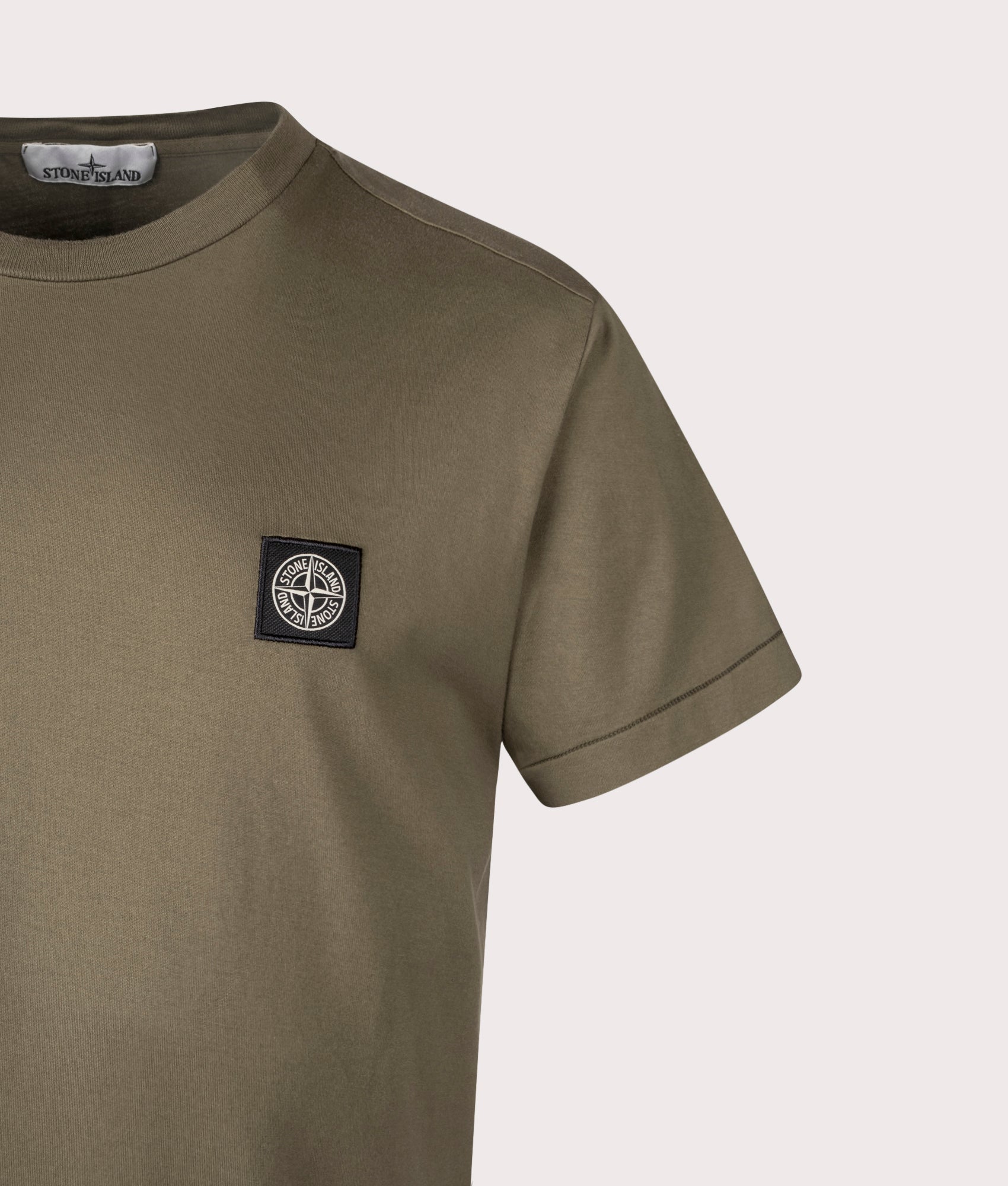 Stone Island Slim Fit Patch T-Shirt in Military Green at EQVVS Menswear. Detail shot.