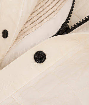 Stone Island Crinkles Reps NY Quilted-TC Jacket in Ivory at EQVVS Menswear. Button detail shot. 