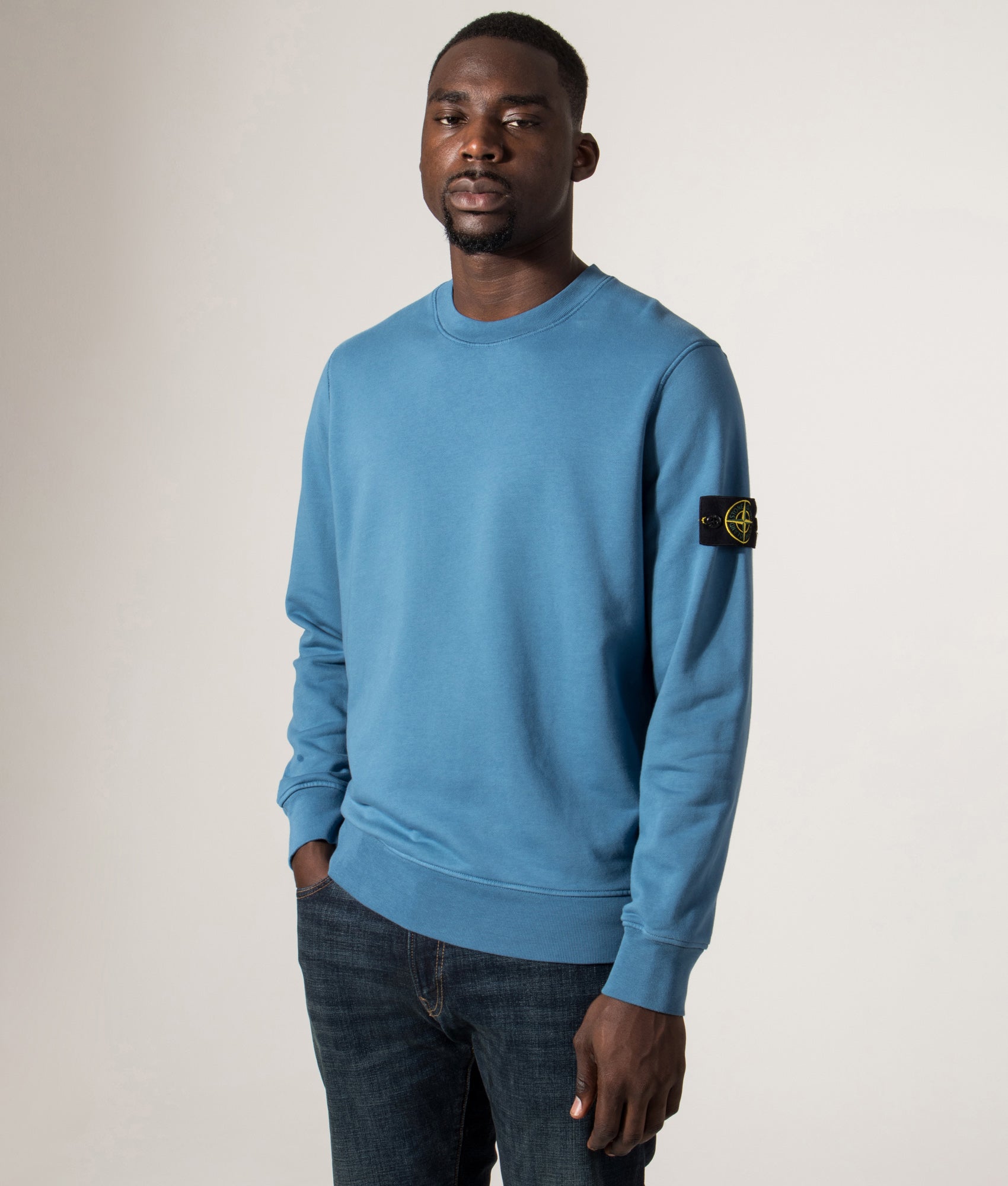 Organic Cotton Crewneck Sweatshirt in Steel Blue. 100% Cotton | Stone Island | Shot at EQVVS | Front angle model shot