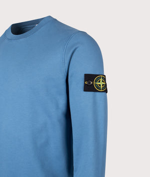 Organic Cotton Crewneck Sweatshirt in Steel Blue. 100% Cotton | Stone Island | Shot at EQVVS | Side angle detail shot 