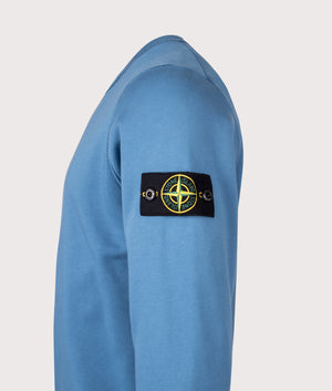 Organic Cotton Crewneck Sweatshirt in Steel Blue. 100% Cotton | Stone Island | Shot at EQVVS | Side detail shot 