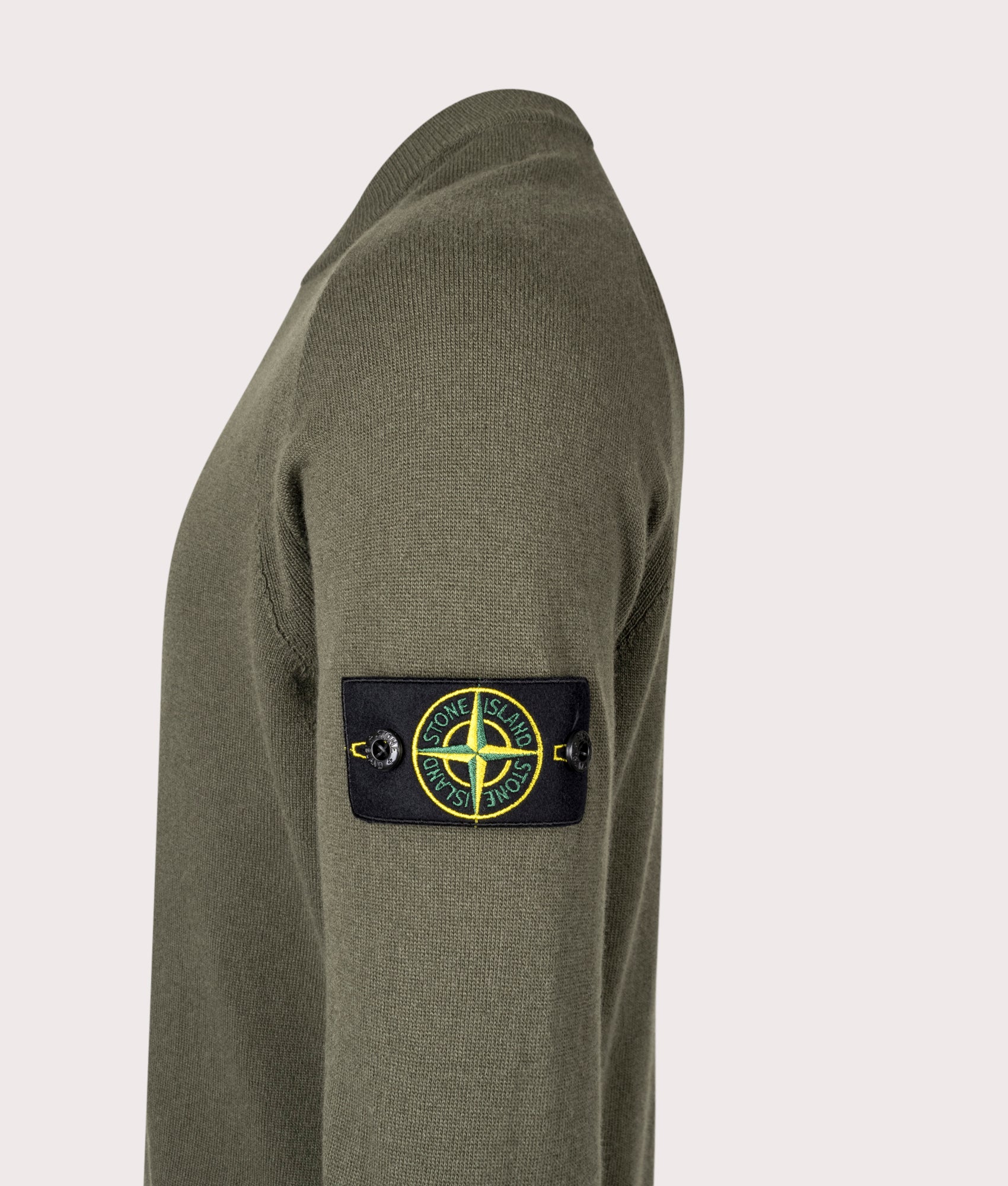 Stone Island Geelong Wool Jumper in Military Green at EQVVS Menswear. Side detail shot.