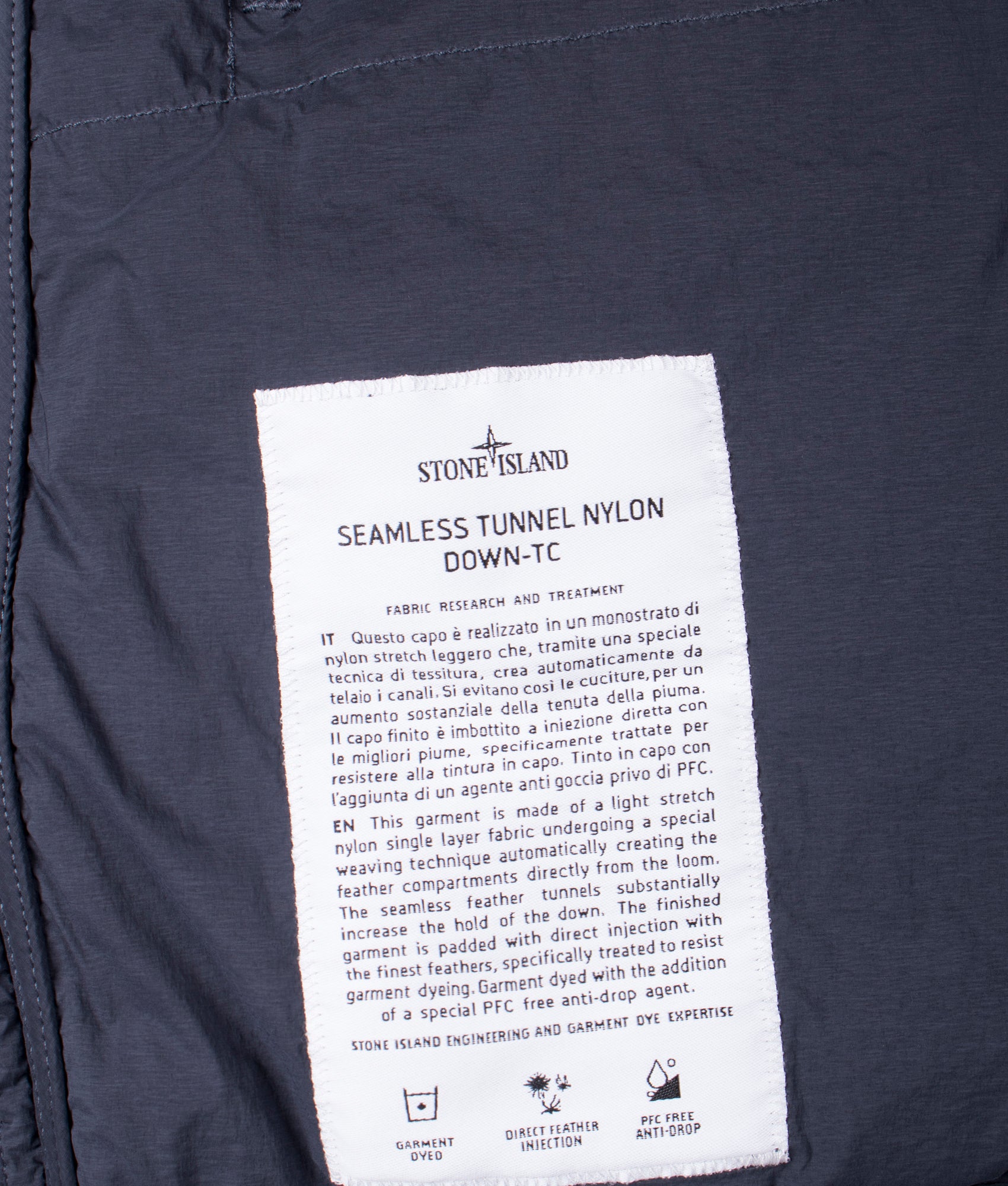 Stone Island Seamless Tunnel Nylon Down TC Jacket in Navy Blue at EQVVS Menswear. Inside label detail shot.