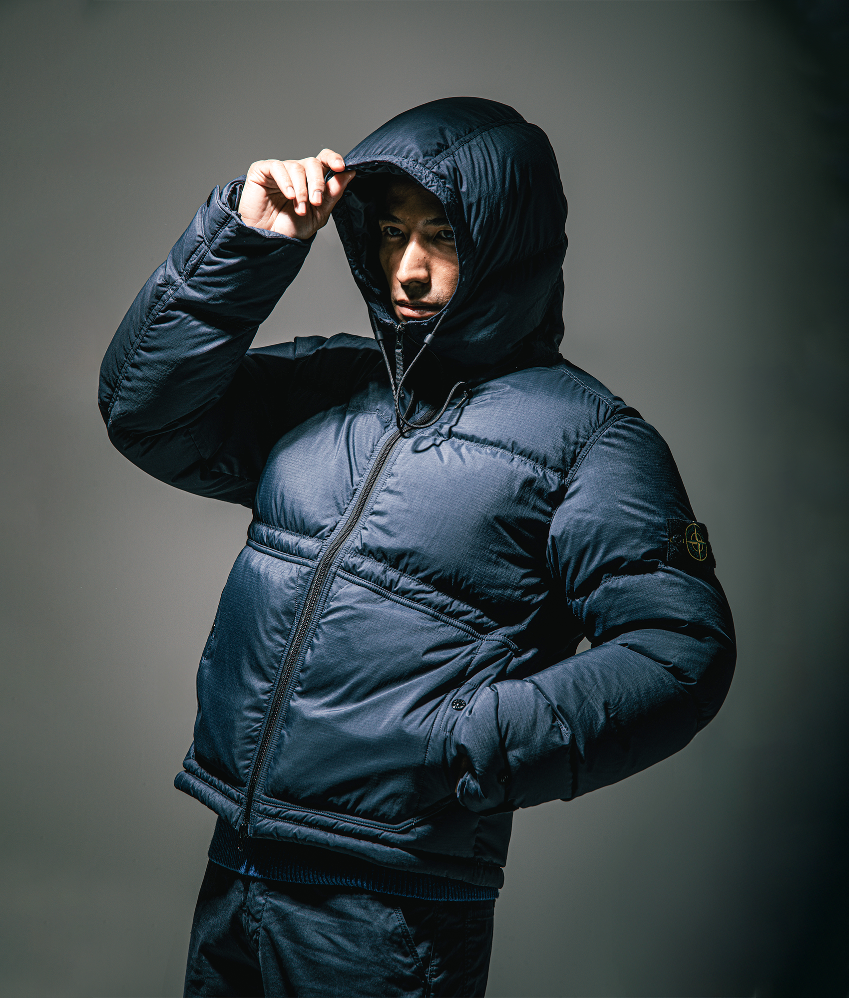 Stone Island Down Parka in Black at EQVVS Menswear. Campaign shot.