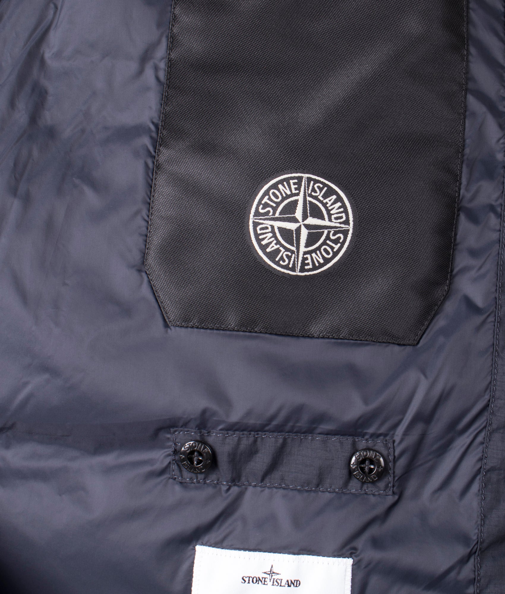 Stone Island Down Parka in Black at EQVVS Menswear. Inside branding shot 