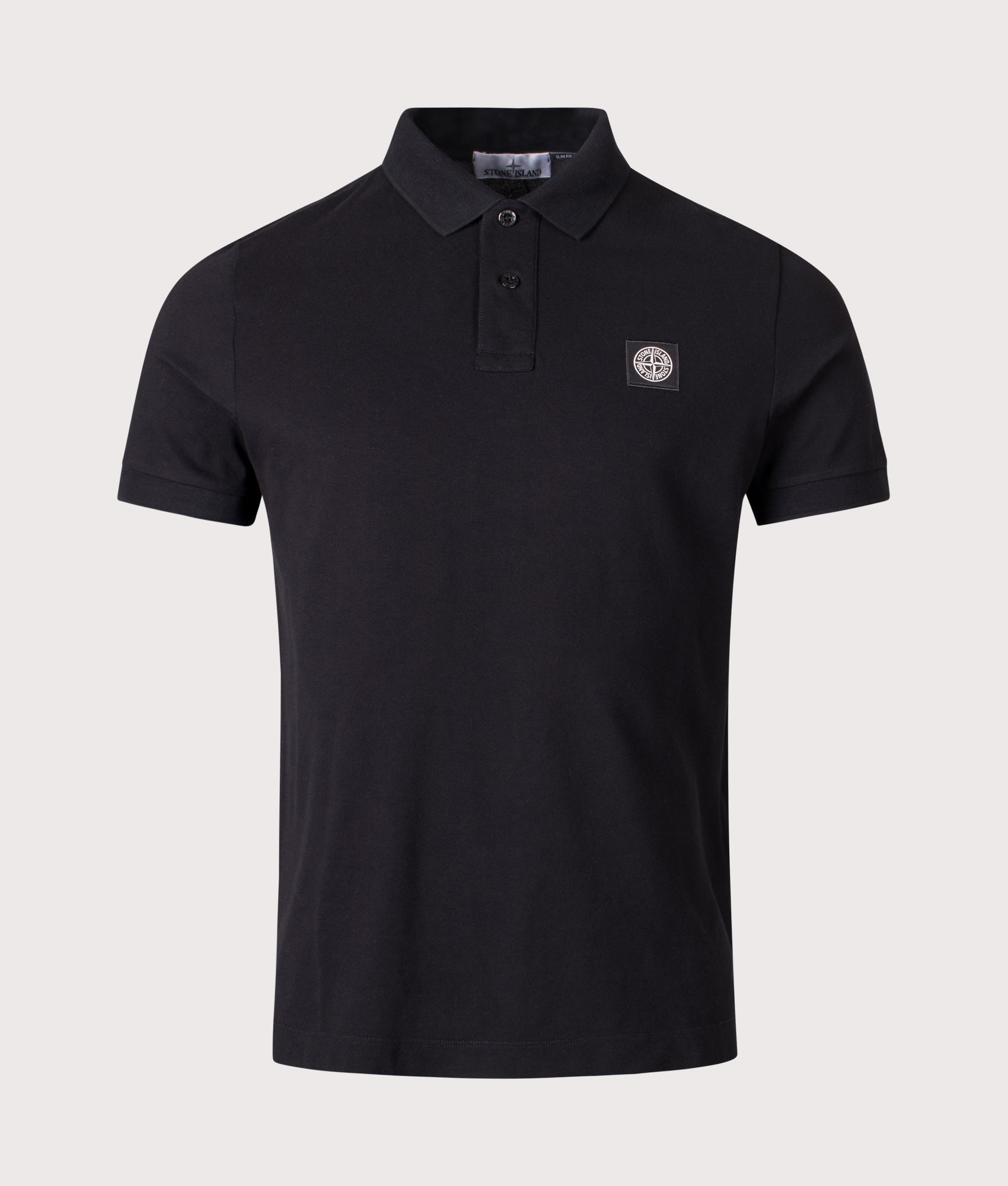 Stone Island Slim Fit Compass Patch Polo Shirt in Black at EQVVS Menswear. Front shot.