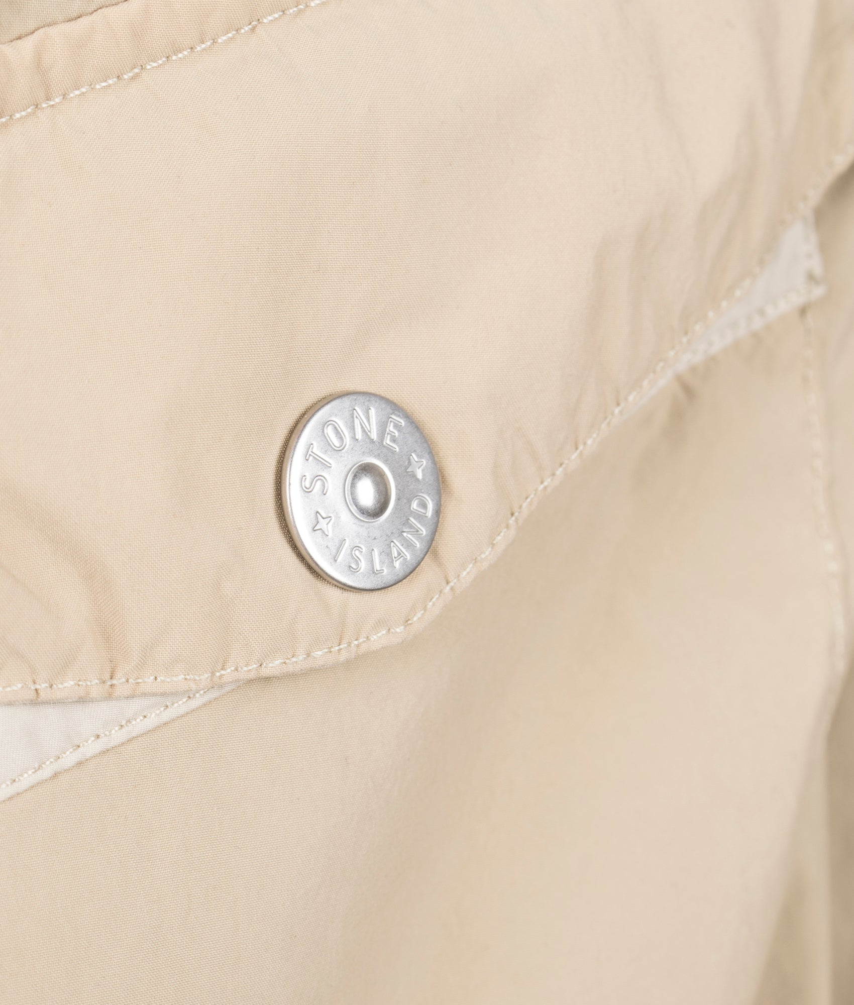 Light Compact Field Jacket by Stone Island in Desert. Shot by EQVVS. Brading detail shot.
