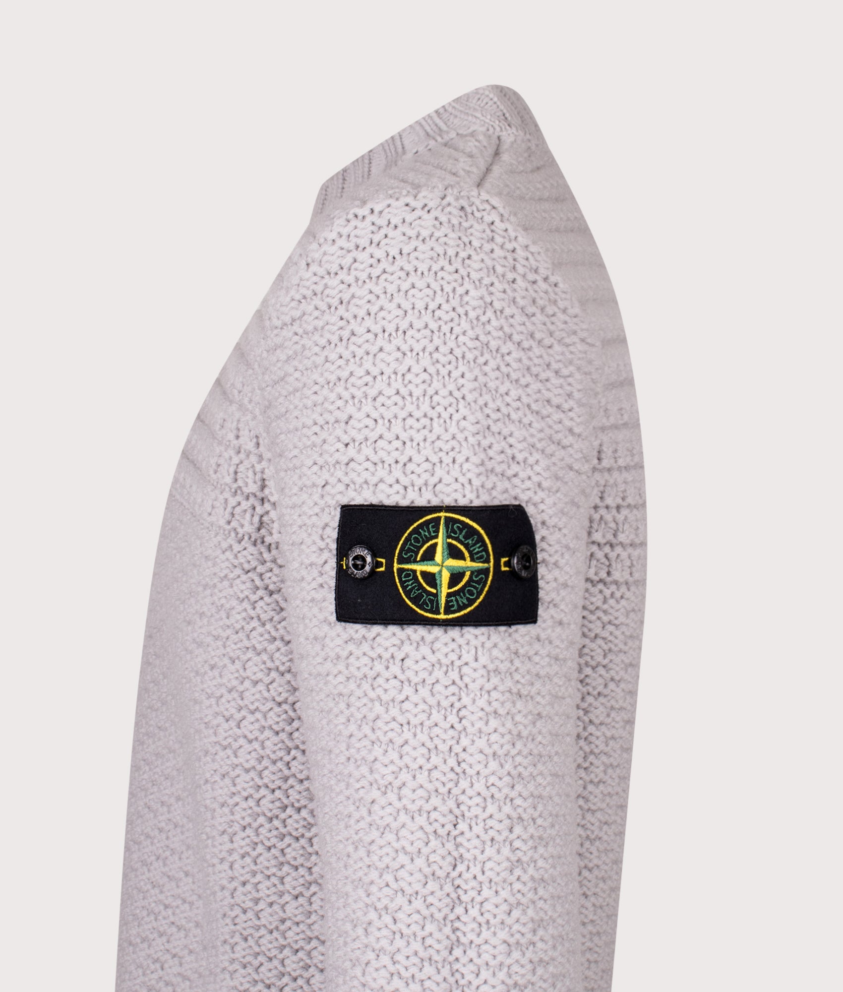 Mock Neck Wool Jumper in Pearl Grey. 100% Wool | Stone Island | Shot at EQVVS | Side detail shot 