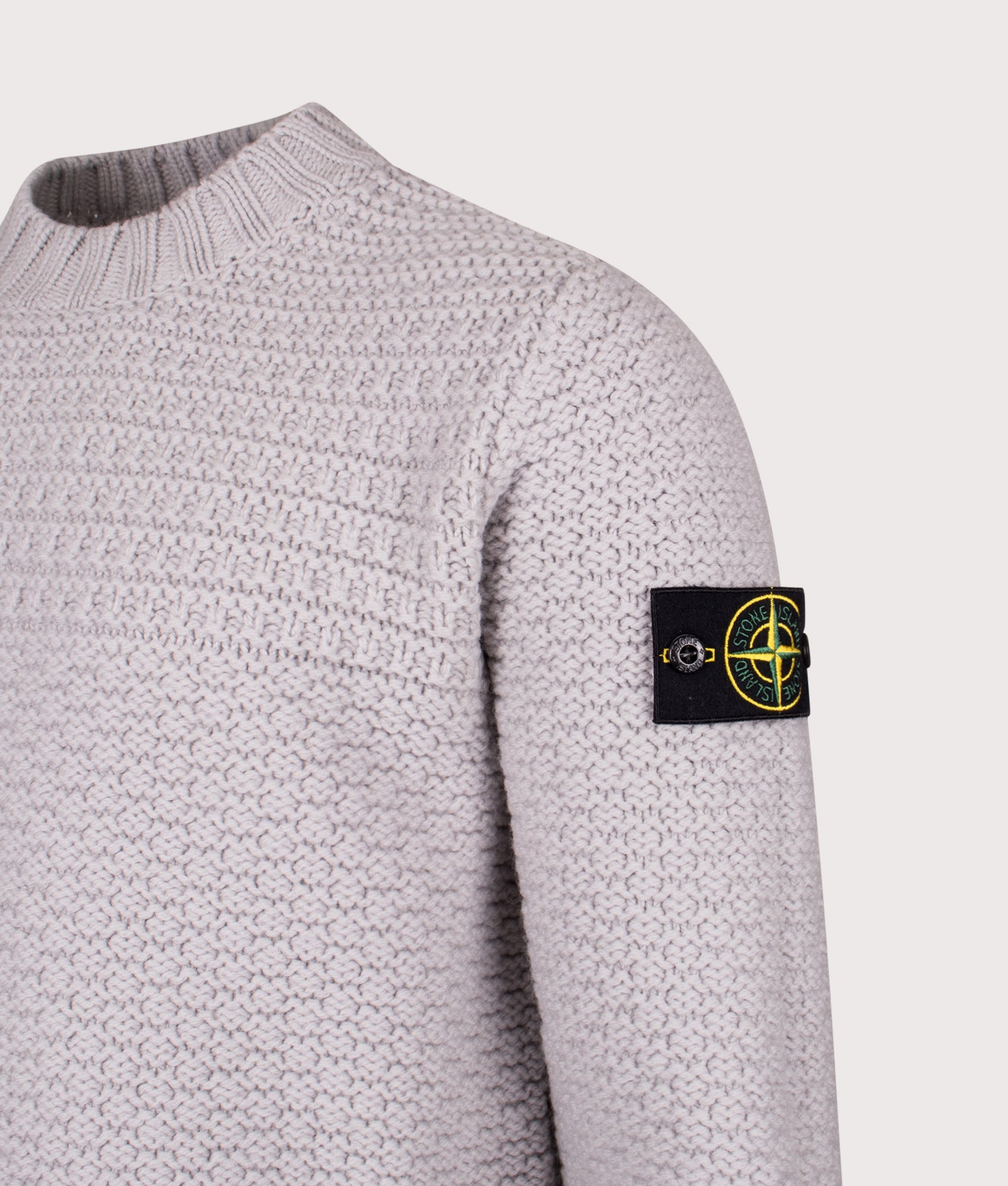 Mock Neck Wool Jumper in Pearl Grey. 100% Wool | Stone Island | Shot at EQVVS | Side angle detail shot 