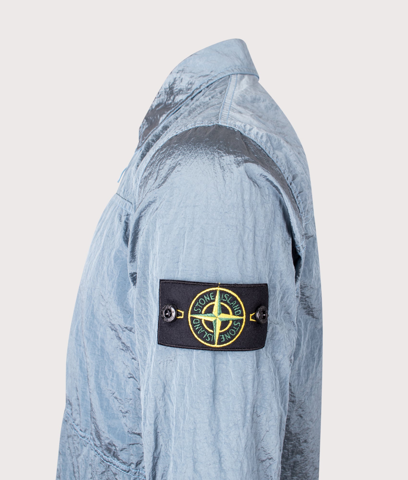 Stone Island Nylon Metal Overshirt in Steel Blue at EQVVS Menswear. Side angle shot 