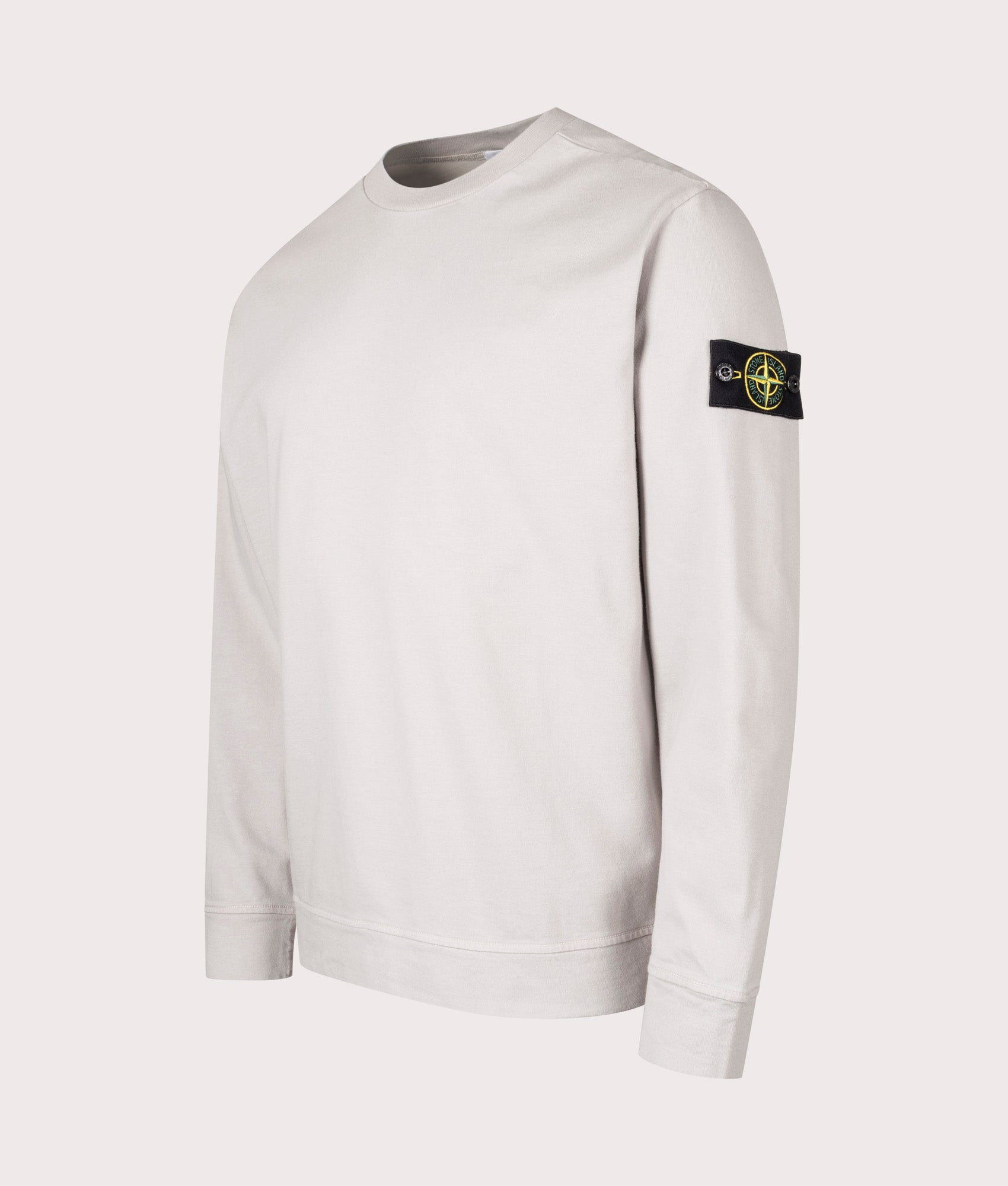 Stone Island Heavy Cotton Sweatshirt in Pearl Grey at EQVVS Menswear. Angled Front shot.