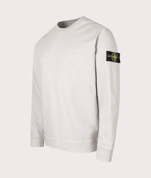 Stone Island Heavy Cotton Sweatshirt in Pearl Grey at EQVVS Menswear. Angled Front shot.