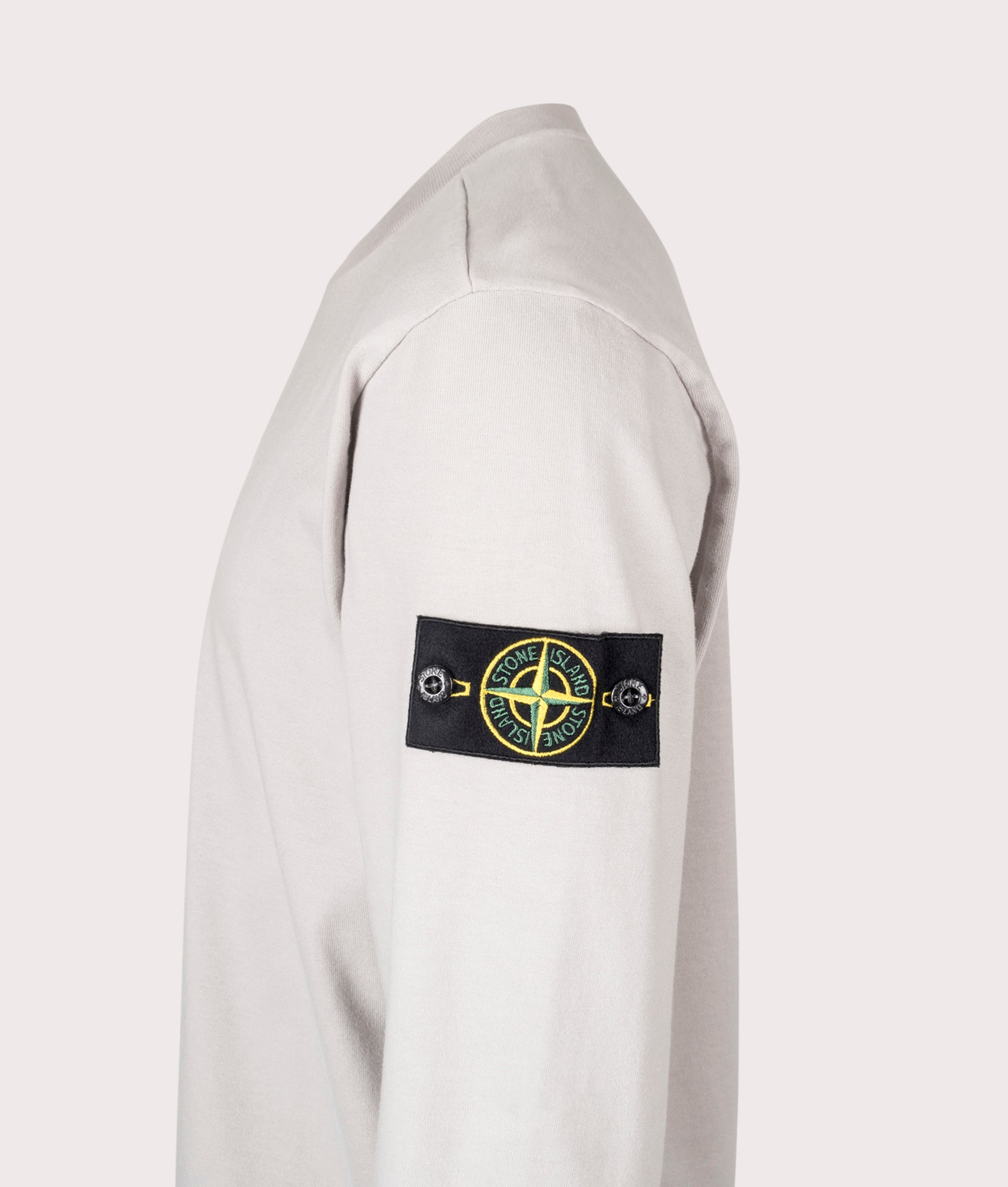 Stone Island Heavy Cotton Sweatshirt in Pearl Grey at EQVVS Menswear. Side detail shot.