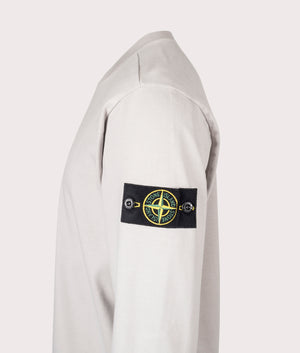 Stone Island Heavy Cotton Sweatshirt in Pearl Grey at EQVVS Menswear. Side detail shot.