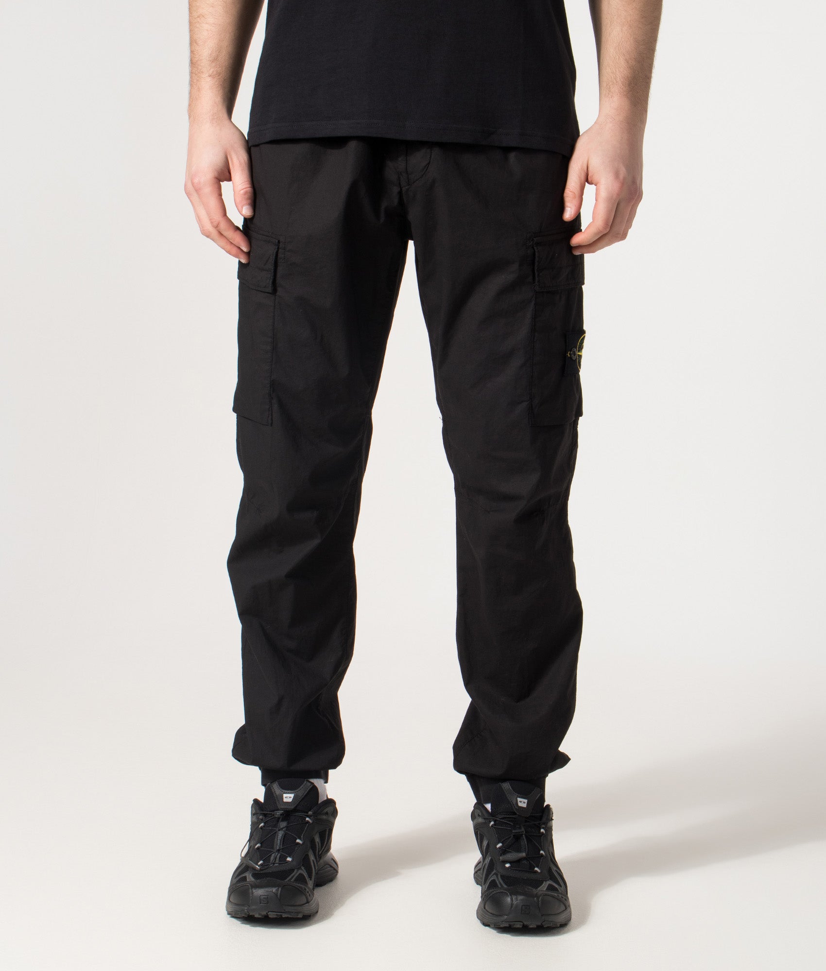 Stone Island Tapered Cargo Pants in Black at EQVVS Menswear. Front shot.