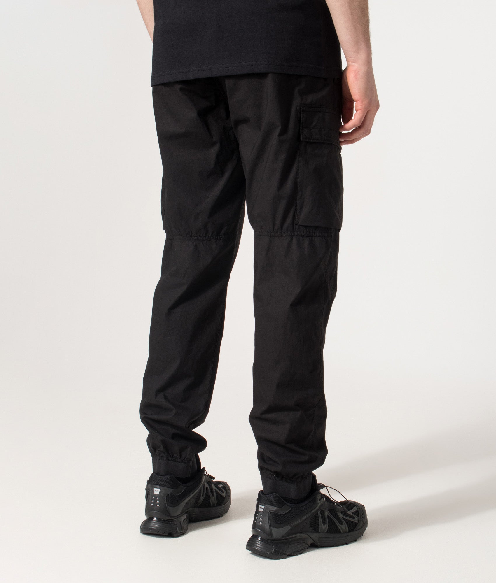 Stone Island Tapered Cargo Pants in Black at EQVVS Menswear. Back shot.