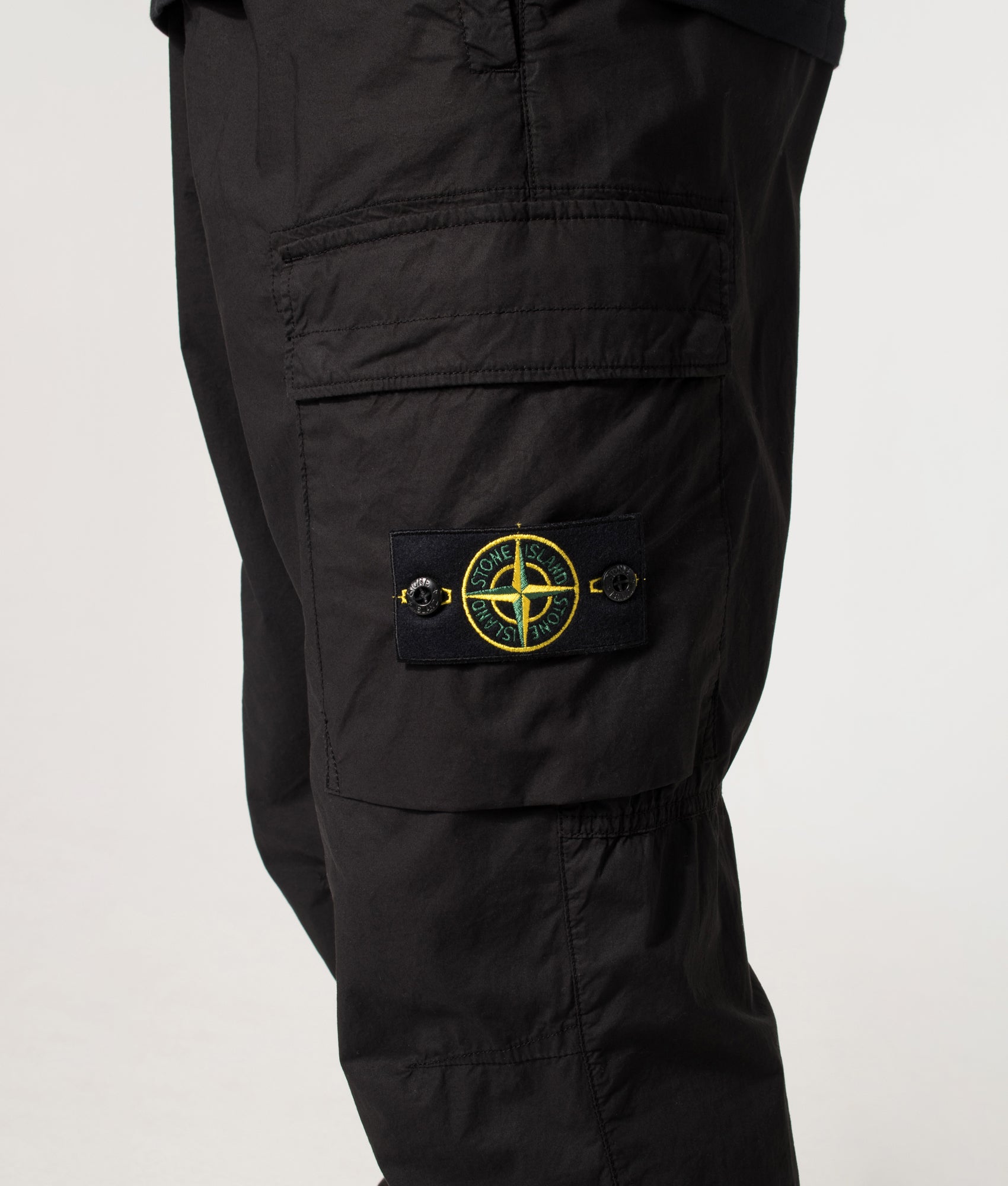 Stone Island Tapered Cargo Pants in Black at EQVVS Menswear. detail shot.