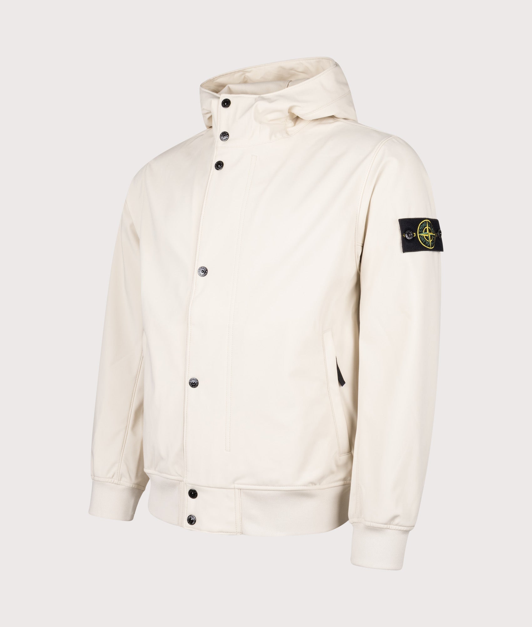 Stone Island Light Soft Shell-R E.DYE® Technology Hooded Jacket in Ivory at EQVVS Menswear. Angled front shot.