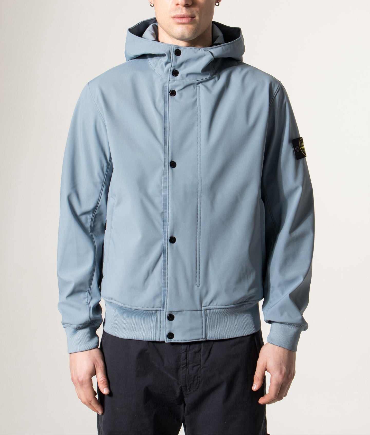 Stone Island release the Light Soft Shell-R E.DYE® Technology Hooded Jacket in Avio Blue at EQVVS Menswear. Model front shot.