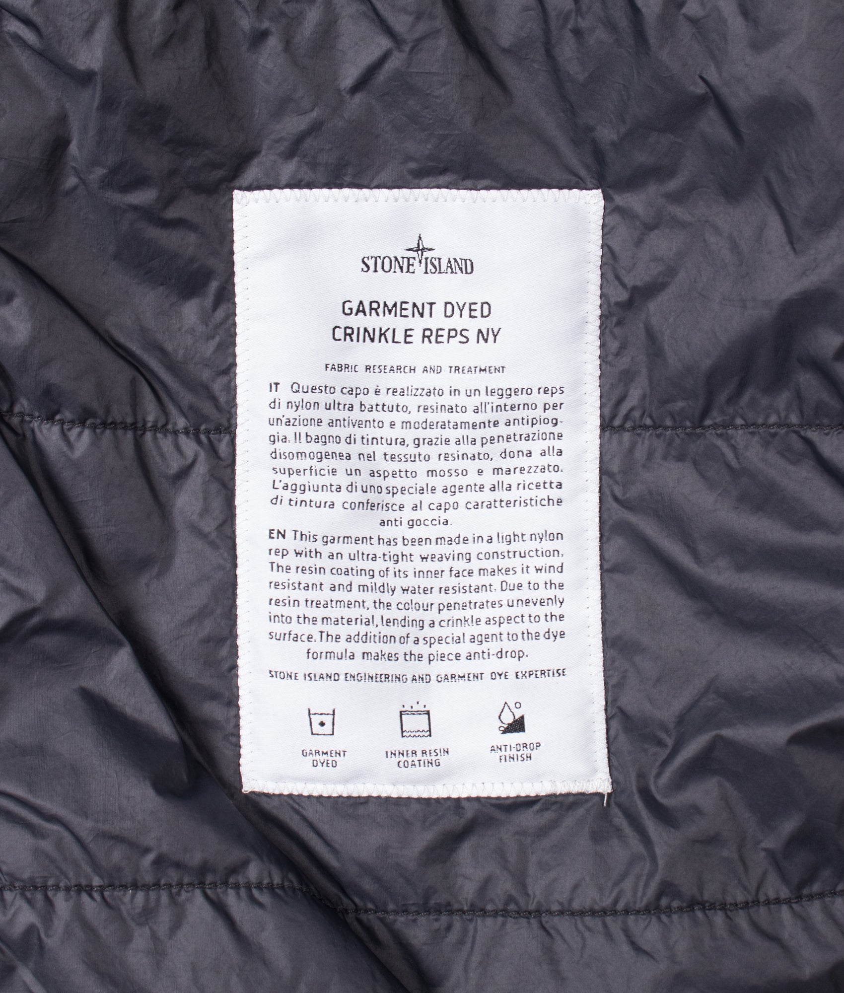 Stone Island Crinkle Reps NY Jacket in Black at EQVVS Menswear. Tag shot.